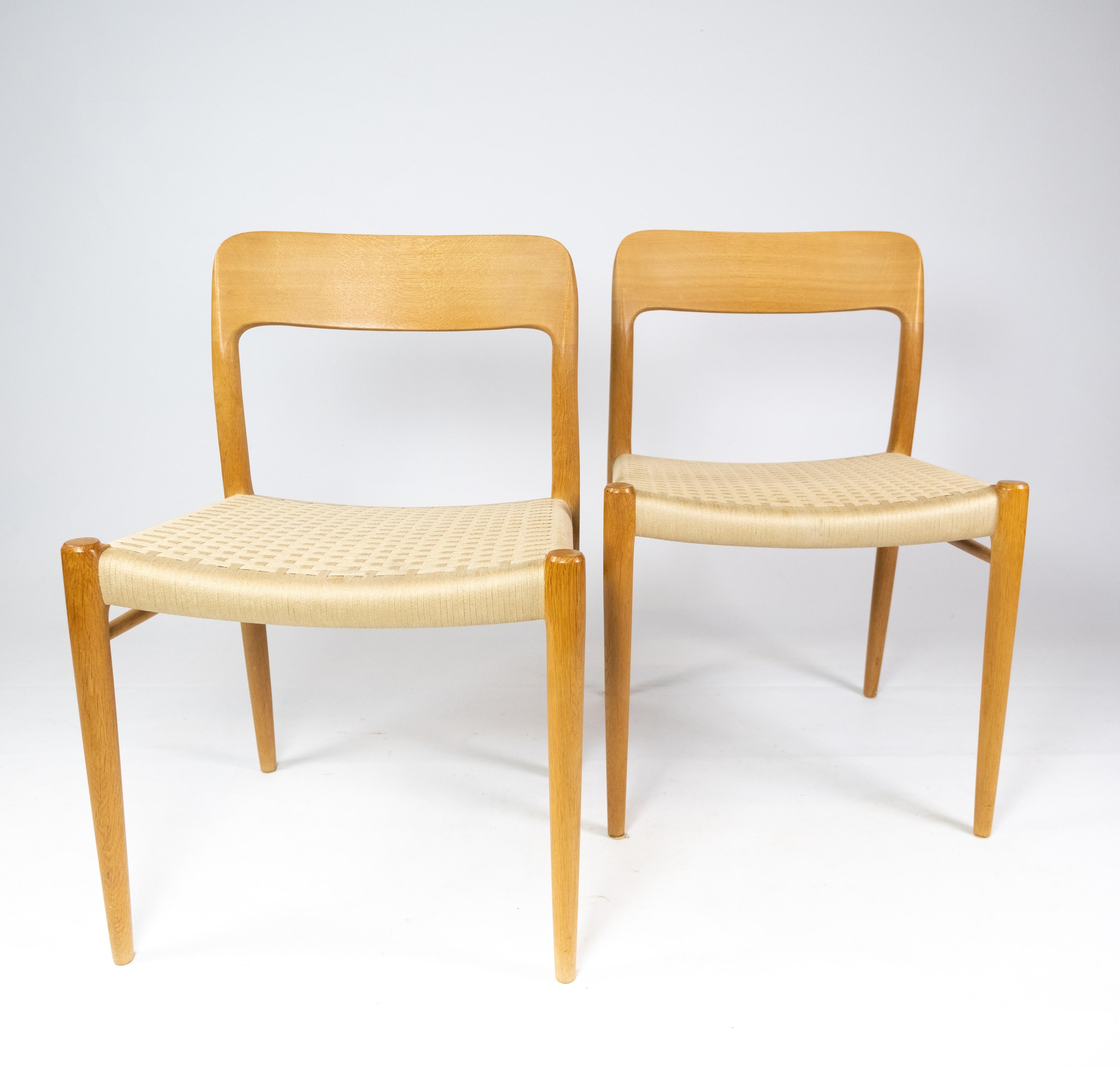 A set of four dining chairs, model 75, in oak and papercord designed by N.O. Møller from the 1960s. The chairs are in great vintage condition and we have 8 in total.
  