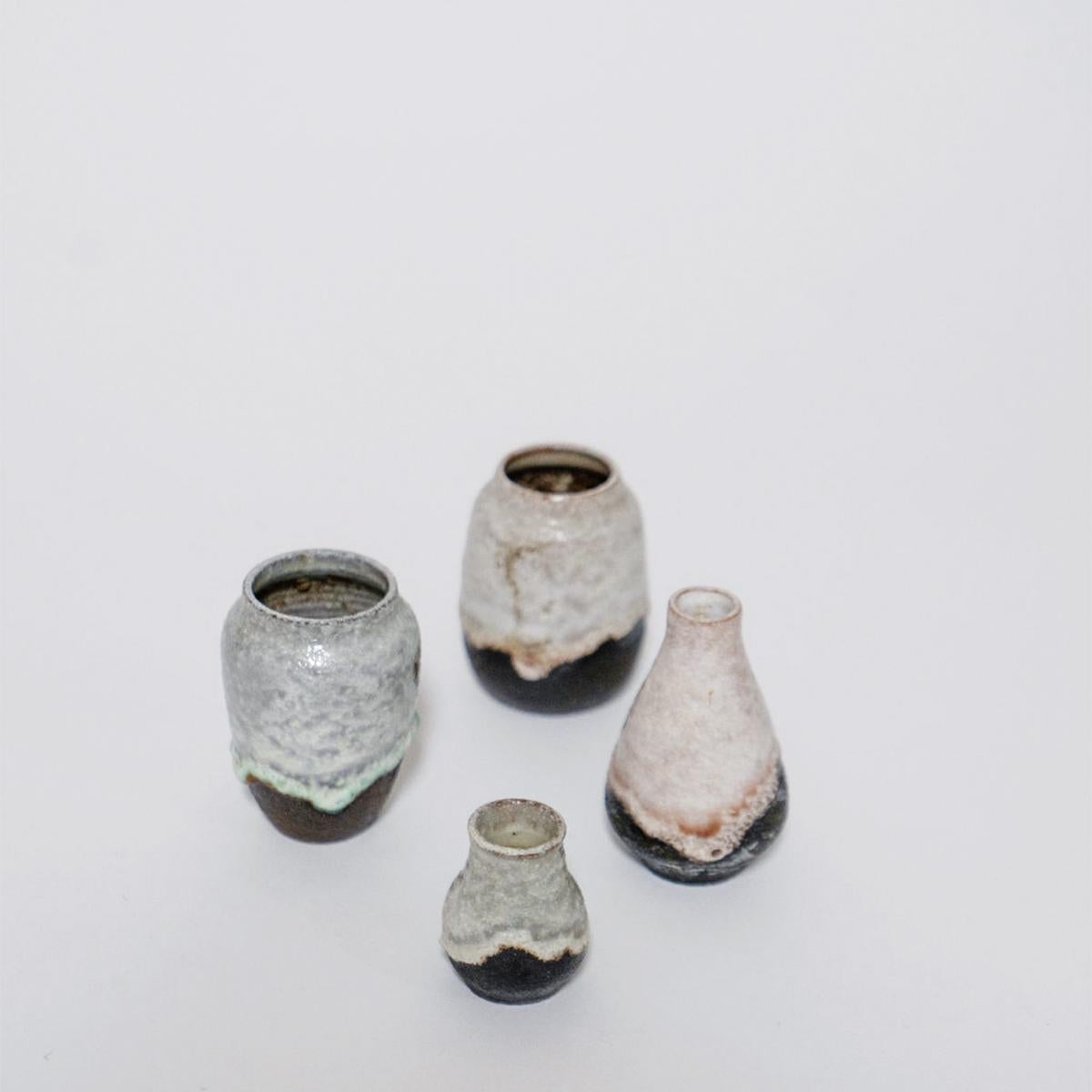 A set of four hand-made Dutch ceramics designed by Henk Goosen and manufactured by Atelier de Steenuil, Rijswijk. Founded in 1947, Atelier de Steenuil produced many vases with drip and effervescent / lava glazes. 

Each vase has an owl logo marked