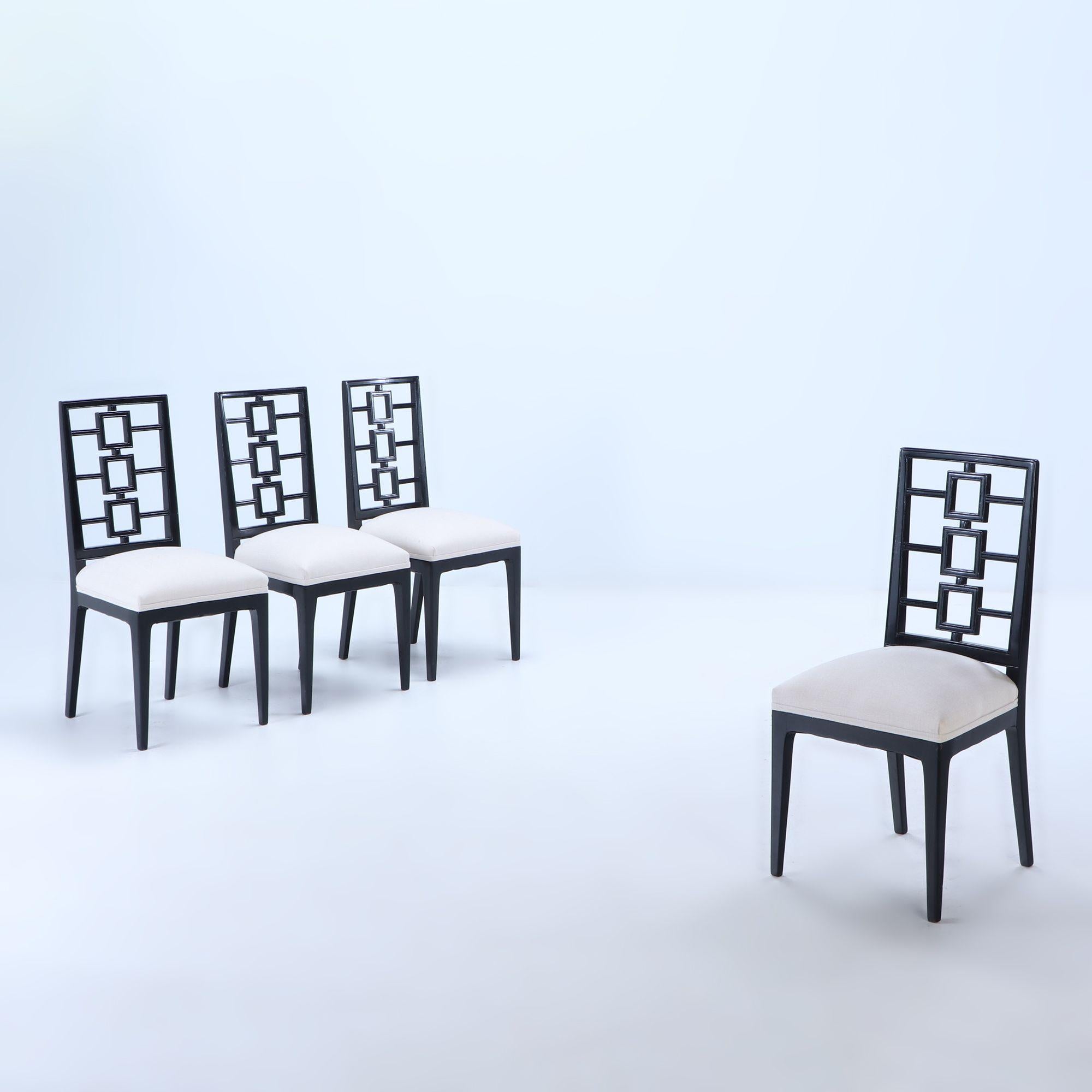 A set of four stylish architectural high back ebonized dining chairs in the manner of Parzinger circa 1950. These are newly reupholstered. We have an additional set of six matching chairs, having different fabric, that can be used together for a set