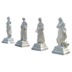 A set of four hand carved statuary marble statues depicting ‘The Four Seasons”