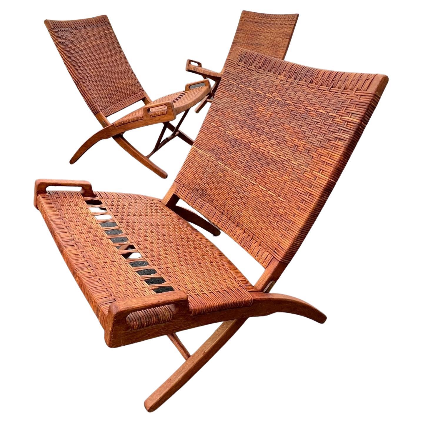A stunning set of four (4) Hans Wegner folding chairs produced by Johannes Hansen, ca' 1950's. Original caning in very good condition and wonderful patina.
