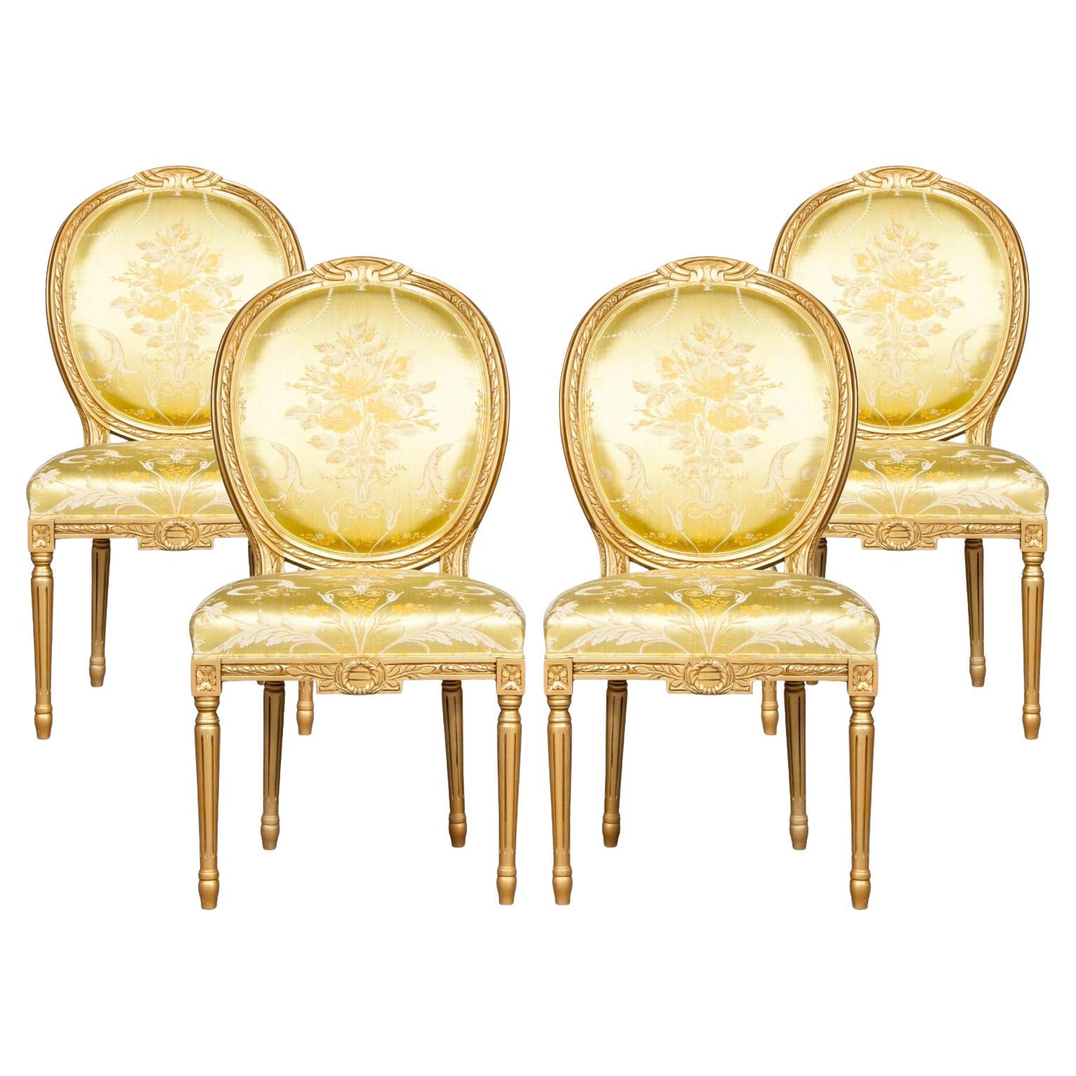 A Set of Four Italian Painted Gilt Wood Frame Louis XVI Style Dining Chairs
