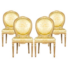 A Set of Four Italian Painted Gilt Wood Frame Louis XVI Style Dining Chairs