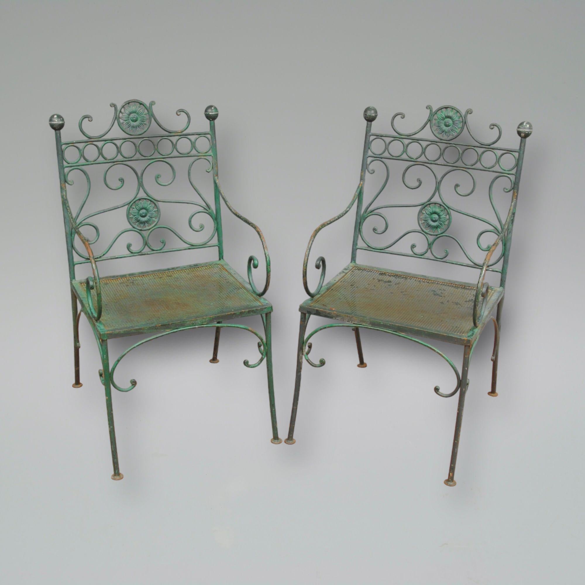 A decorative set of four green painted french metal garden armchairs.
