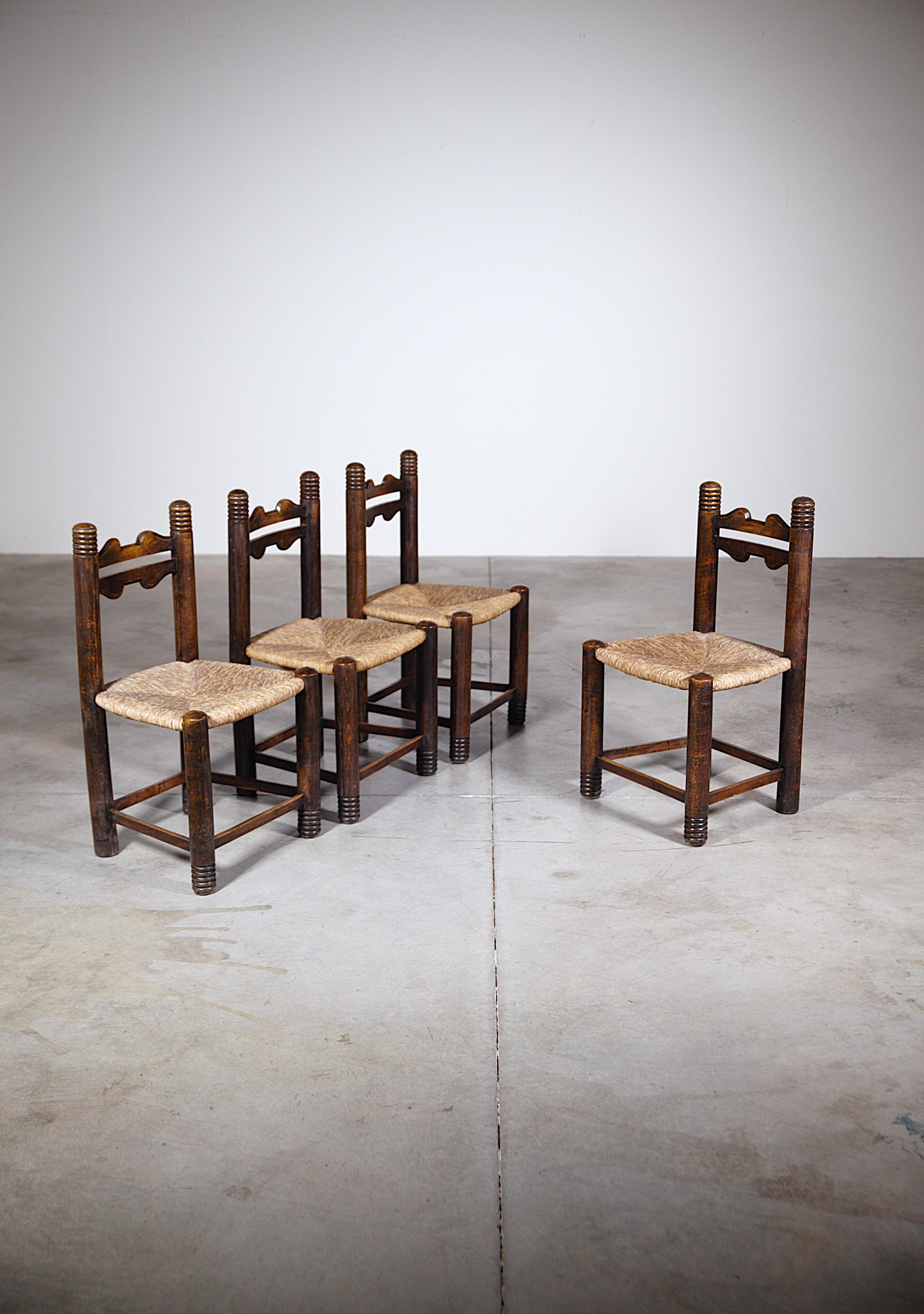 A Set of Four Mountain Dining Chairs France 1960's.

Stained oak.

Straw seats in good condition, stable.

Attractive detail of turn wood on the ends of the legs and uprights of the chair.

In good condition.