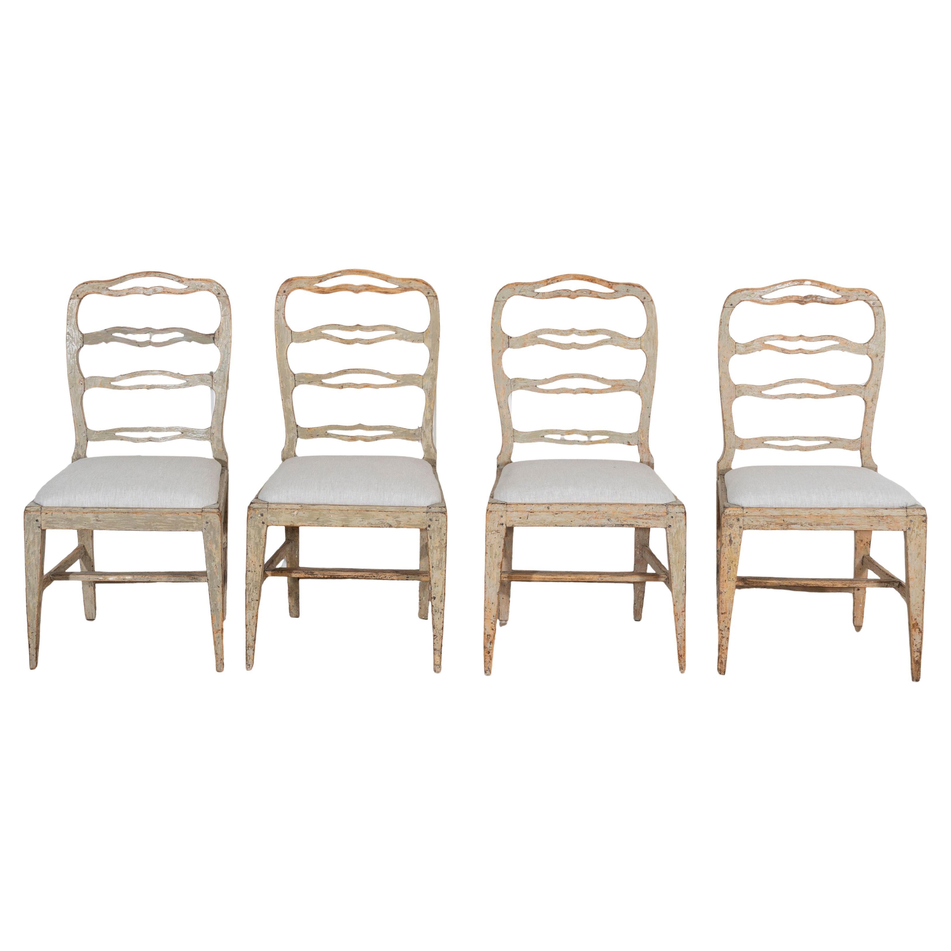 A set of four period Gustavian chairs scraped to original paint and newly covere For Sale