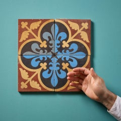 A Set Of Four Reclaimed Encaustic Floral Quatrefoil Tiles