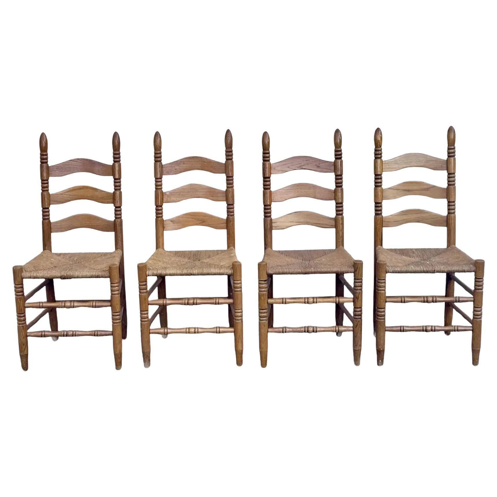 A Set of Four Rustic Vintage Oak and Rush Seat Dining Chairs With Ladder Backs