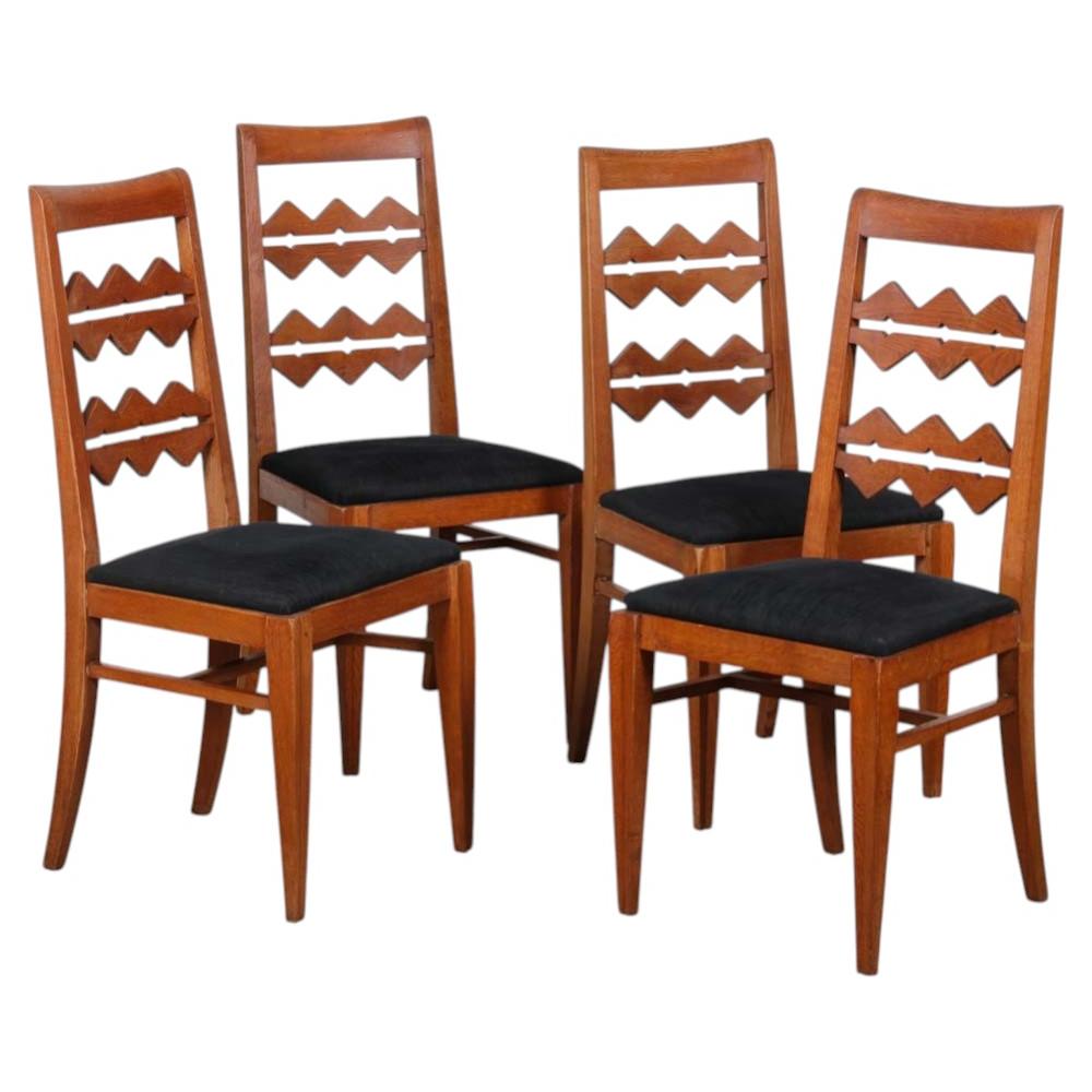 A set of four solid oak chairs from the 1950s For Sale