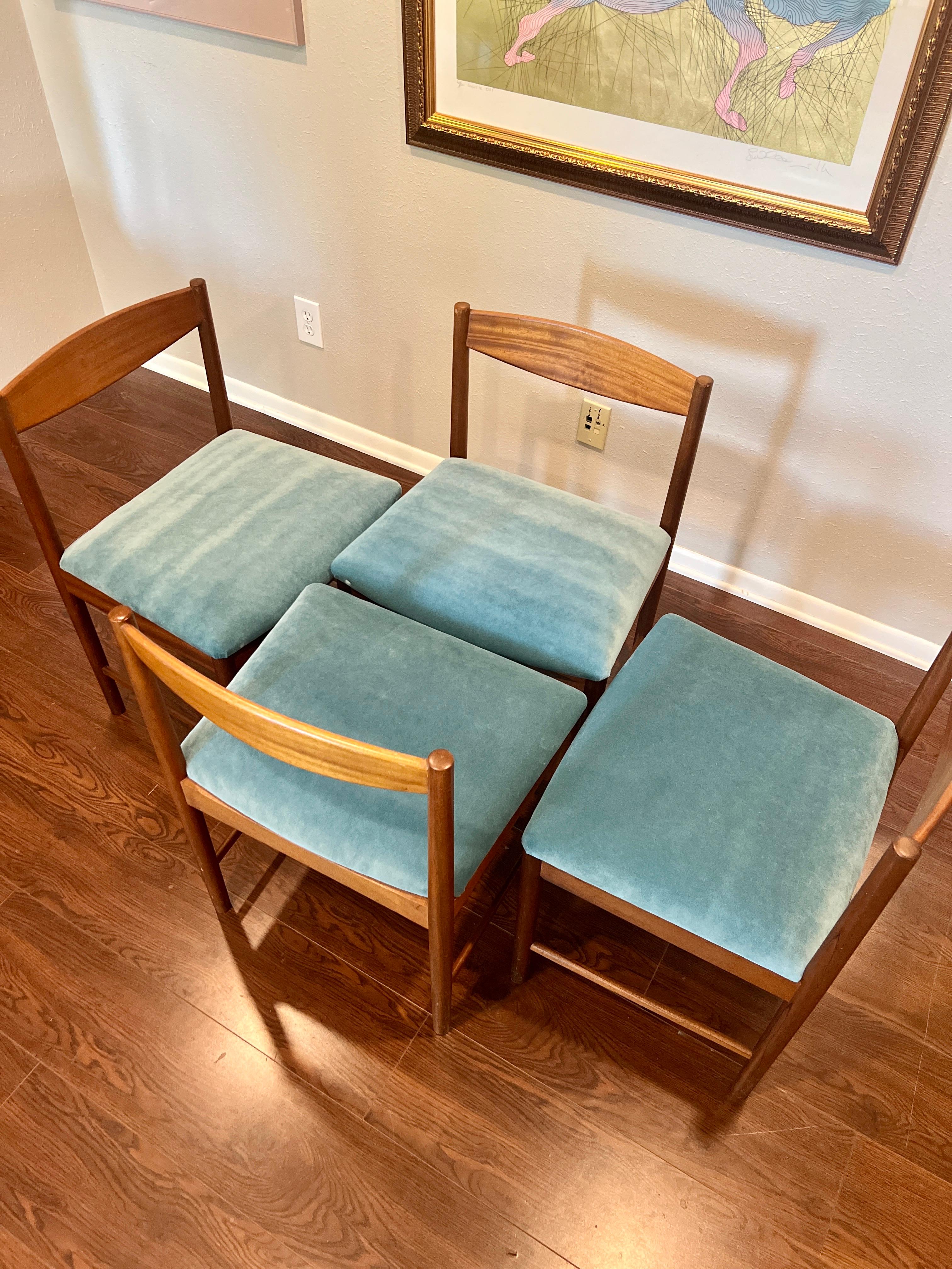 A set of four teak dining chairs by Tom Robertson for A.H McIntosh blue velvet 4