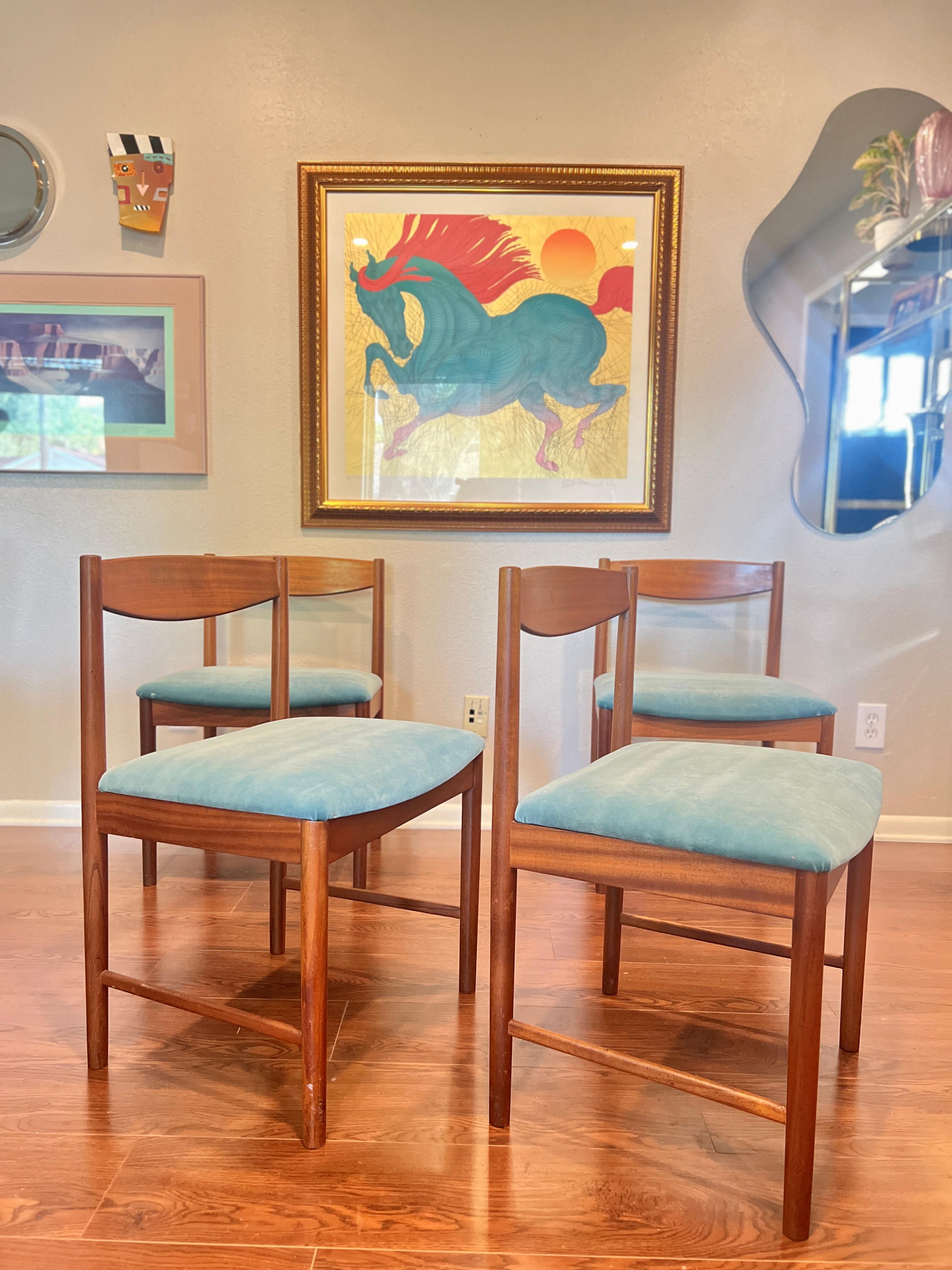 A set of four teak dining chairs by Tom Robertson for A.H McIntosh blue velvet 10