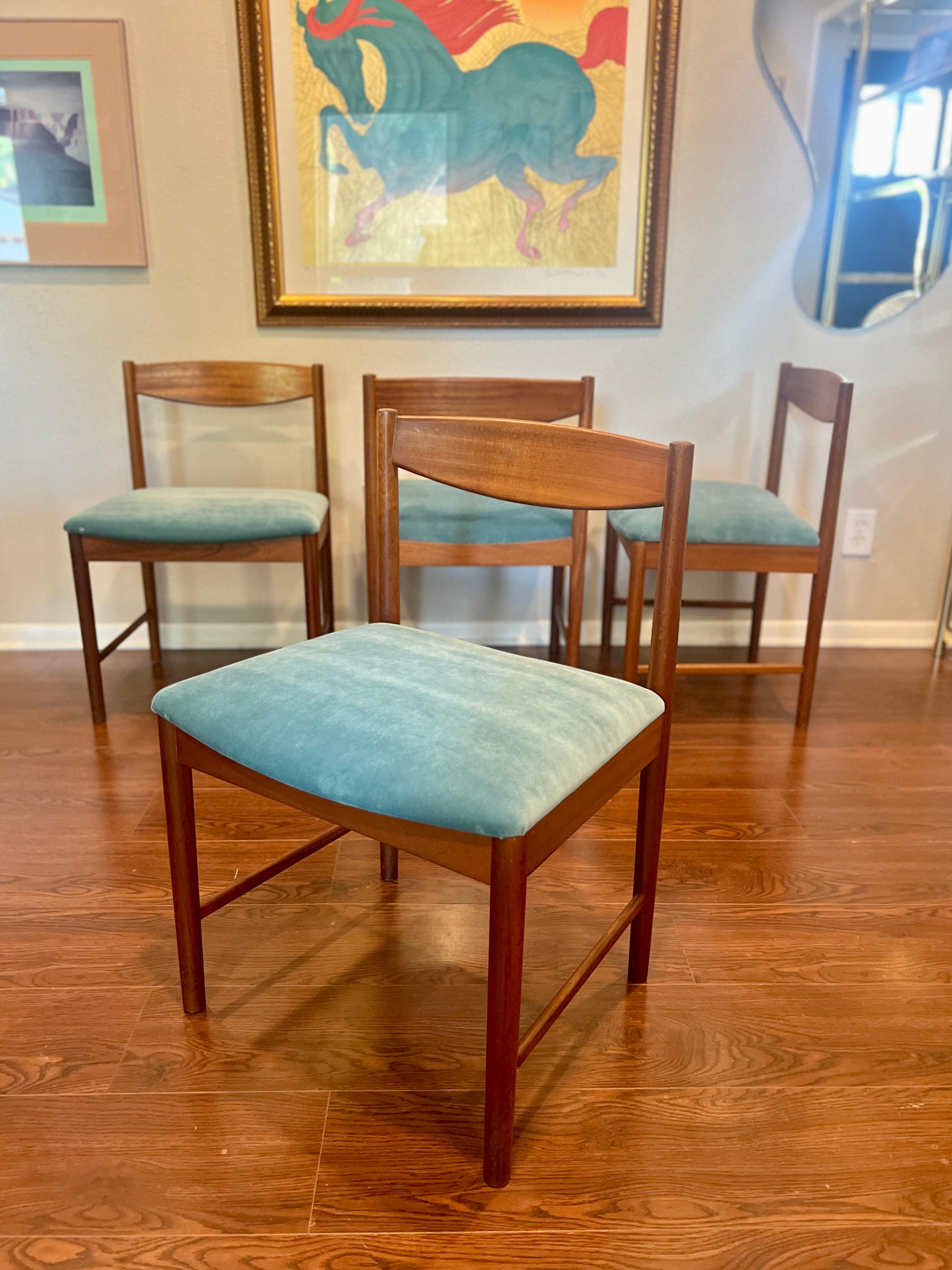 A set of four teak dining chairs by Tom Robertson for A.H McIntosh blue velvet 1