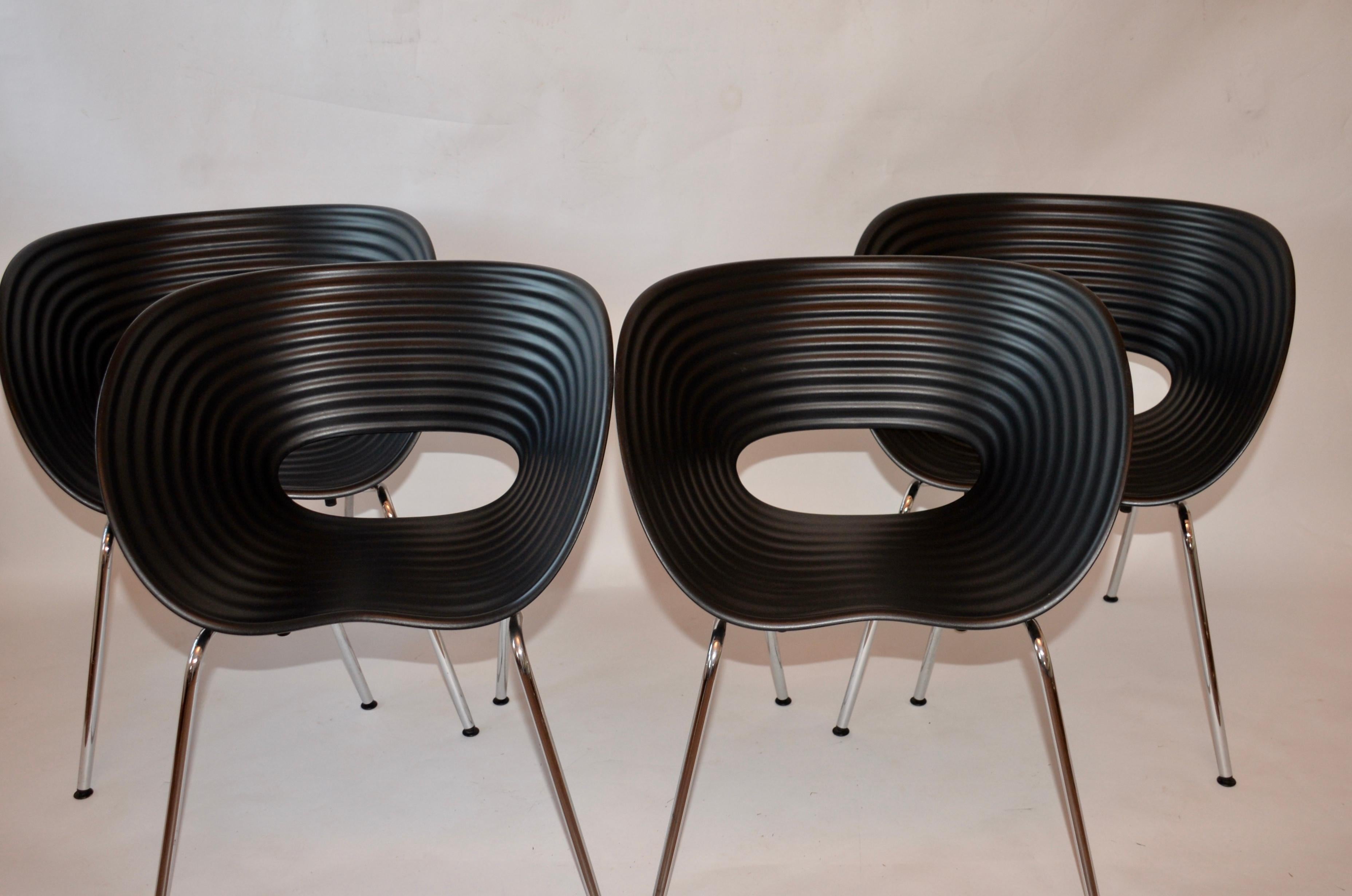 Four iconic Tom Vac chairs by Ron Arad in black. The moulded polypropylene shell offers comfortable seating and retards fading of the color, so suitable for indoor and outdoor use, chrome-plated base and genuine labels to verify the manufacturer as
