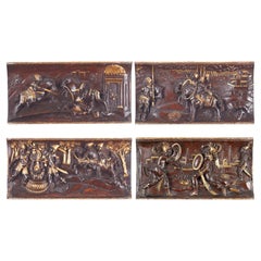 Ensemble de quatre reliefs équestres toscans en bois sculpté et parcellaire doré