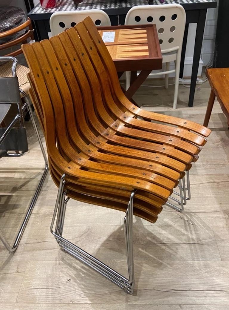 A set of four original vintage Teak Scandia Junior chairs, designed in 1957 by acclaimed Norwegian designer Hans Brattrud for Hove Møbler.

These iconic chairs feature gently curved backs formed from laminated wood slats, offering a sleek,