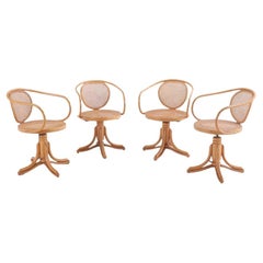 A set of four ZPM Radomsko natural lacquered Thonet style swivel arm chairs. C 1