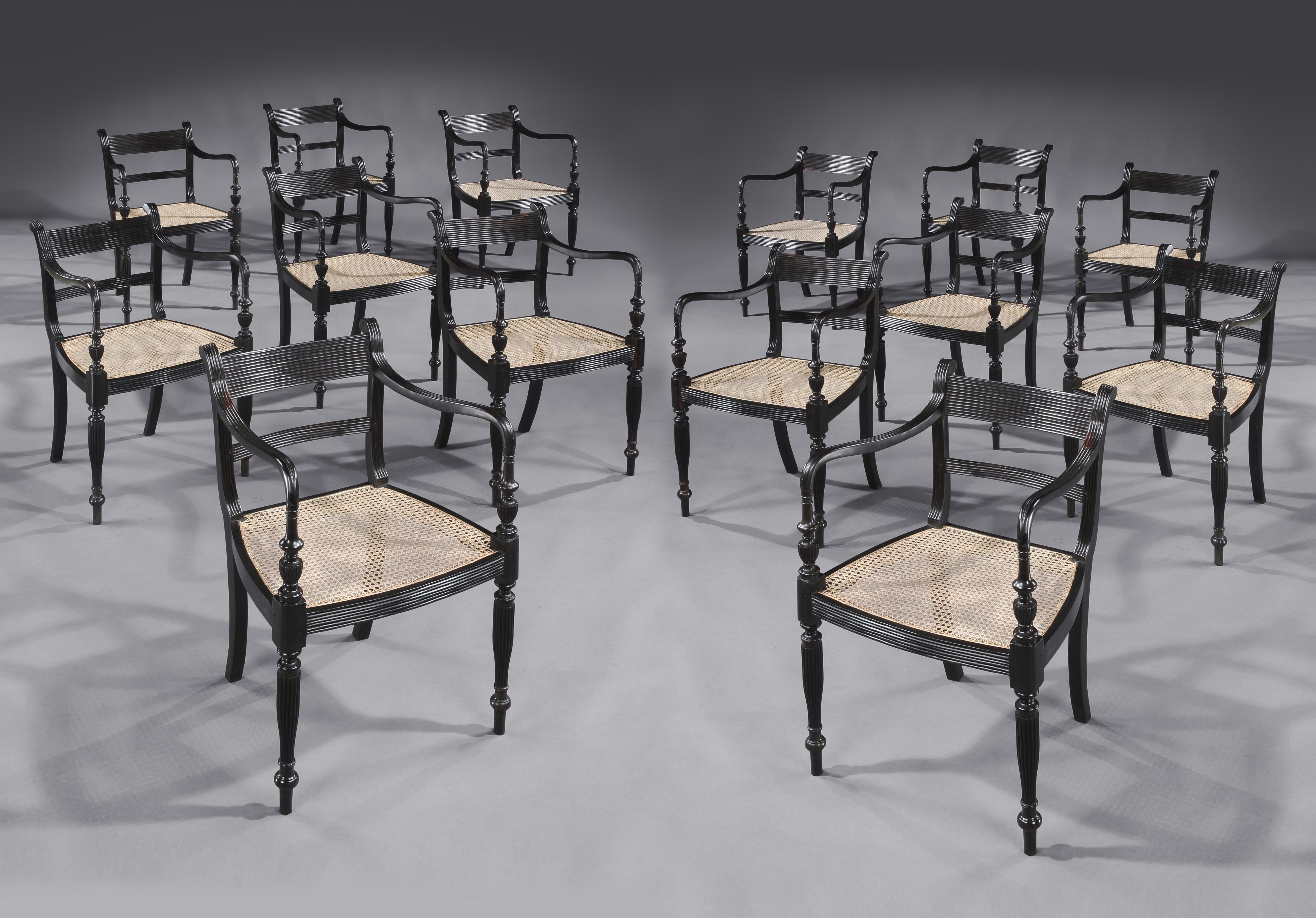 A rare set of fourteen Anglo Indian Regency Ebony armchairs,
The reeded backs above a central splat, with reeded arms,
resting on turned reeded legs, with bergere seats.
Ceylon, Circa 1830.