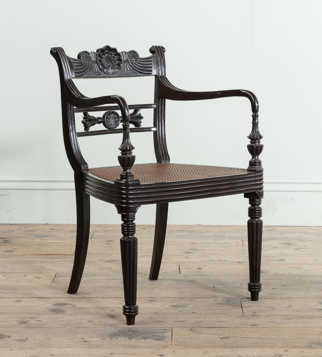 English A Set of Fourteen Early 19th Century Anglo Indian Carved Ebony Armchairs For Sale
