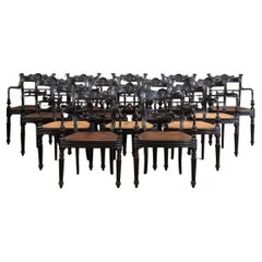 A Set of Fourteen Early 19th Century Anglo Indian Carved Ebony Armchairs