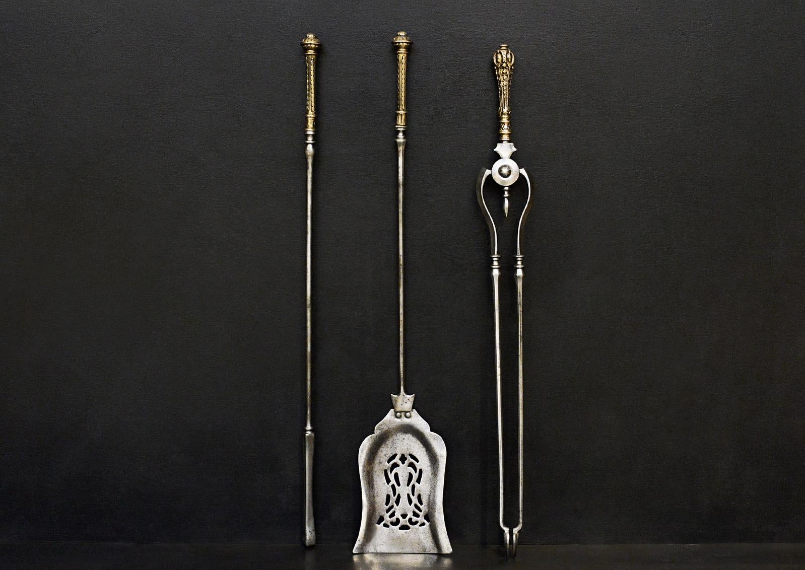 A set of Georgian style steel firetools with shaped pierced shovel and decorative brass handles. (NB. Handles to tongs slightly different design.)

Additional information:
Length: 760 mm / 29 ⅞