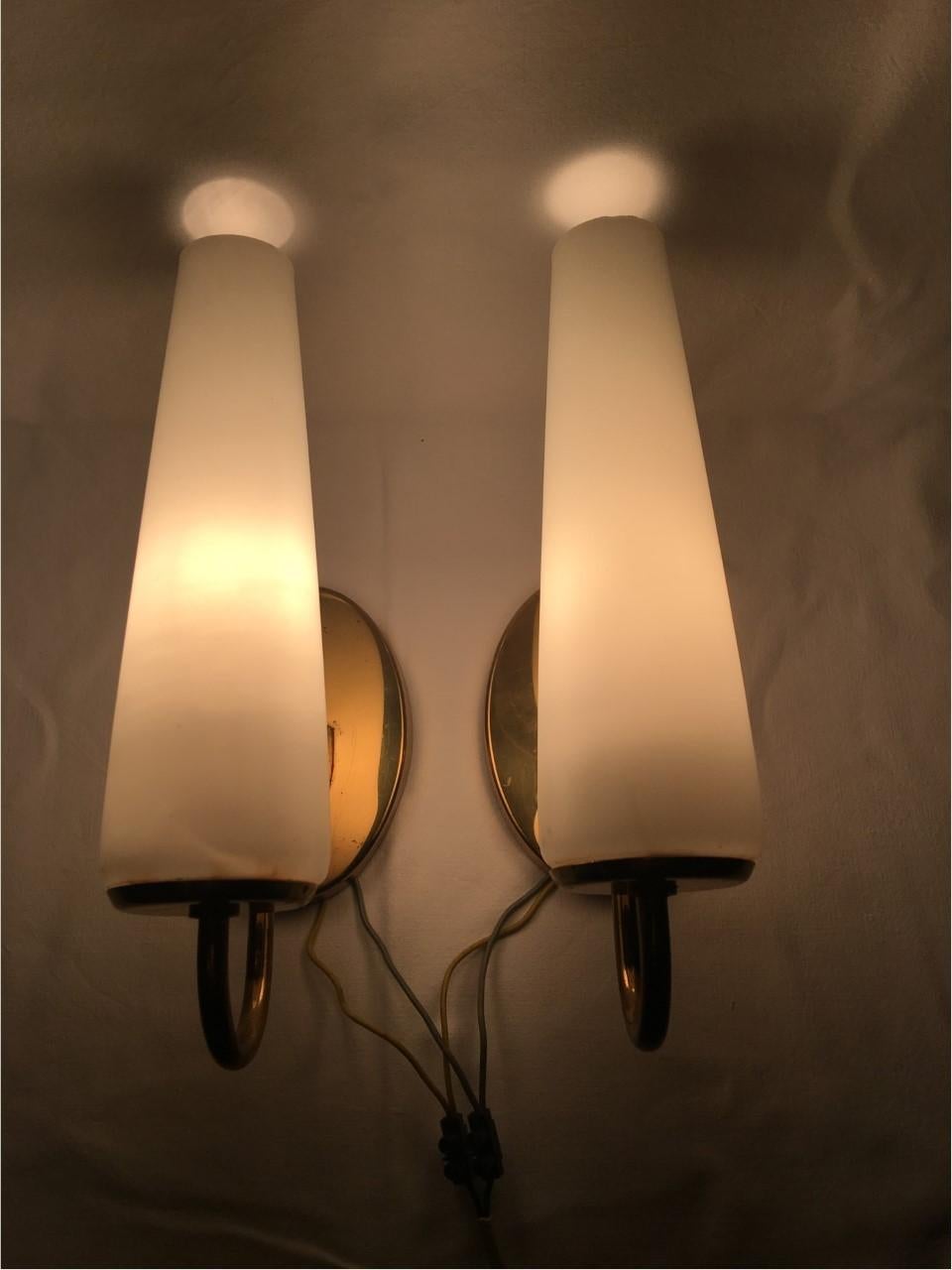 A good looking art deco set of 1930s German Bauhaus copper and milk glass sconces. Made of copper, brass and milk glass. These sconces were manufactured by hand and are in great condition considering normal wear and tear with their age. Each fixture