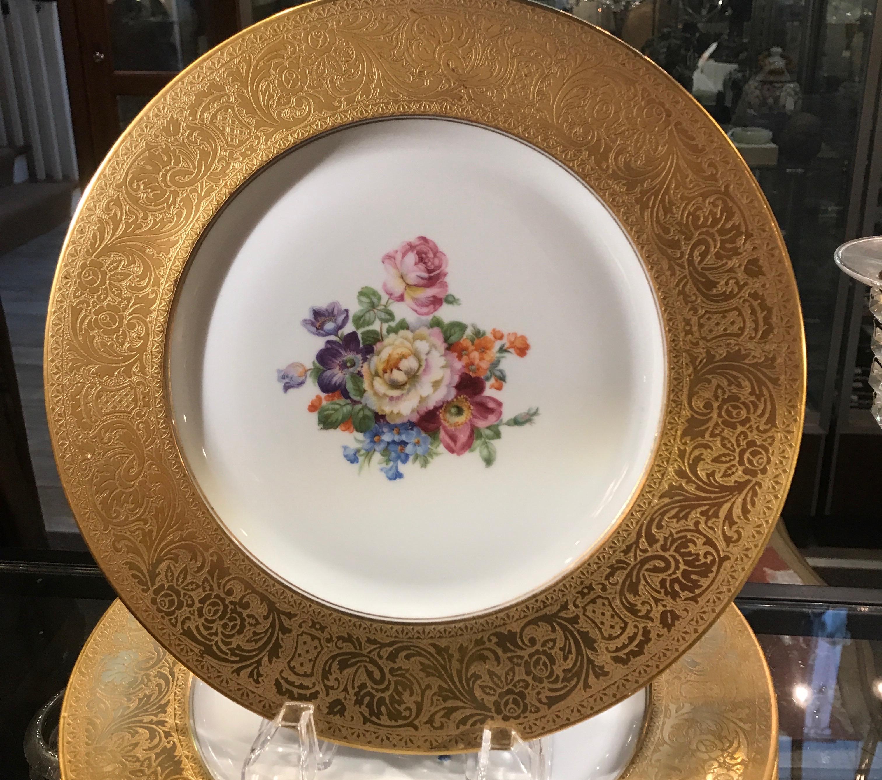 12 Heinrich and Co elegant service plates with thick gold borders and Dresden style floral centers, Early to mid 20th century, Germany.