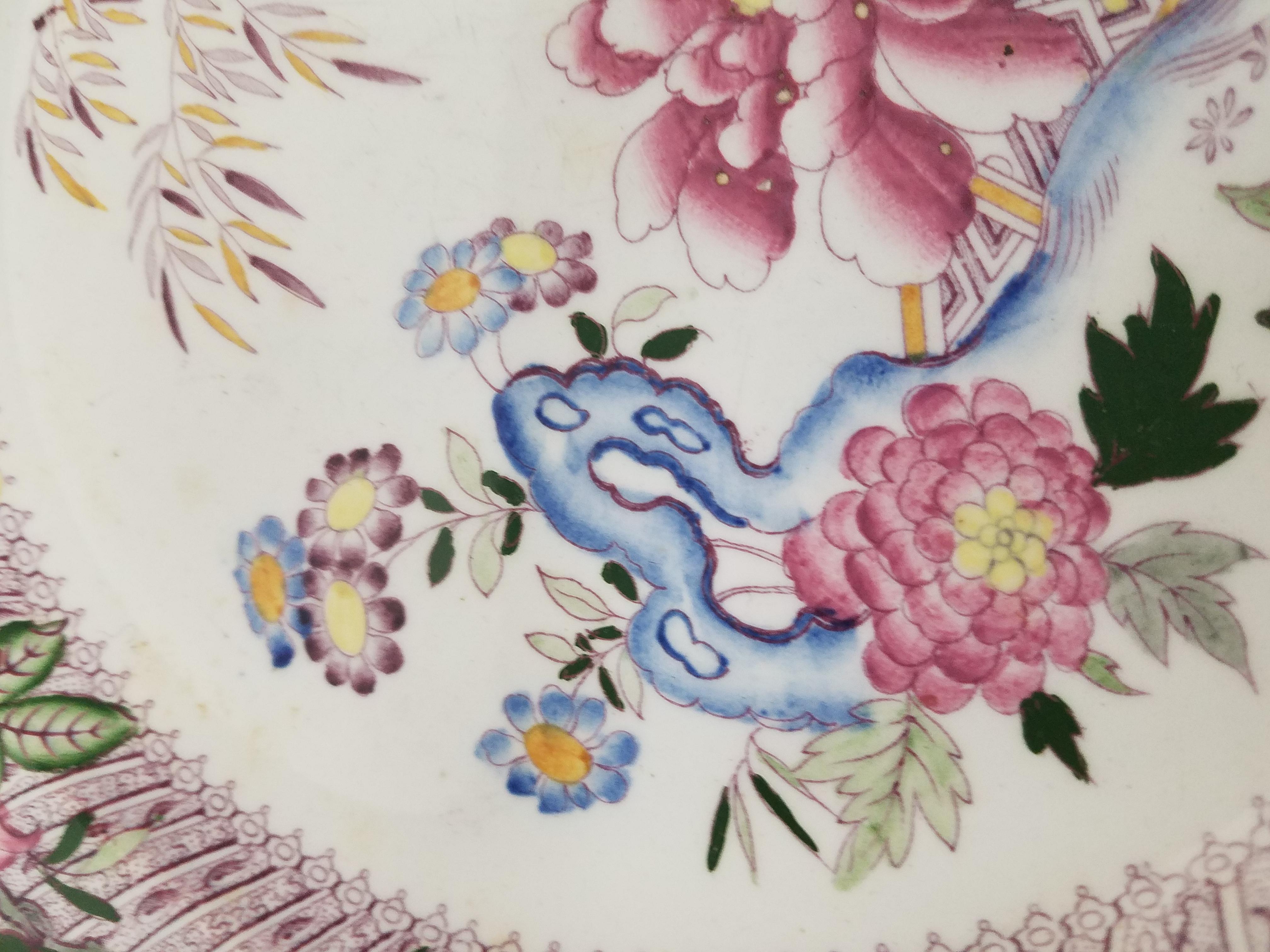 Wonderful mid-19th century English Dinner Plates with polychrome chinoiserie Design. The layered border with a transfer decoration with an overlay of hand enabled Asian floral motif. One showing a blue underglaze mark suggesting these are Minton,