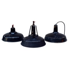 A set of industrial black enamel hanging lamps circa 1940s