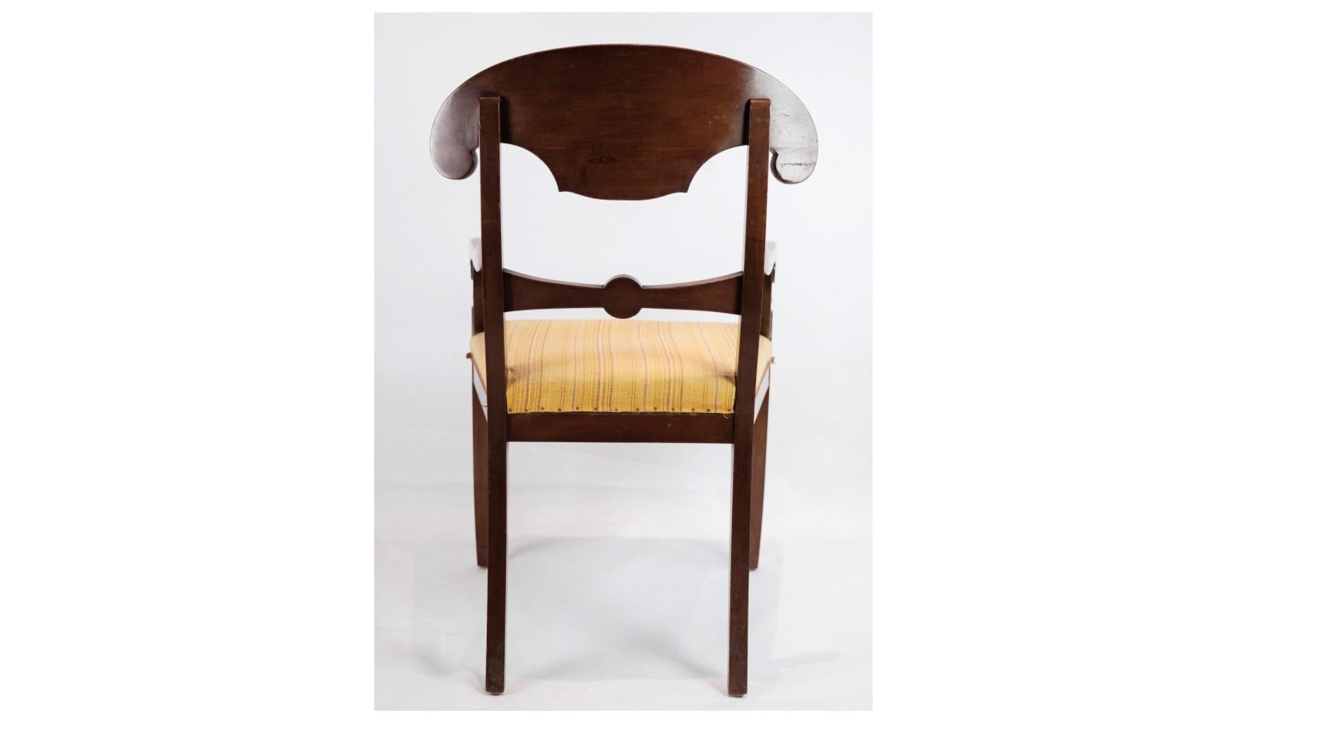 The set of two armchairs made in mahogany with light fabric from the 1860s is a testament to the timeless beauty and craftsmanship of Victorian-era furniture. Crafted from luxurious mahogany wood, renowned for its rich color and durability, these