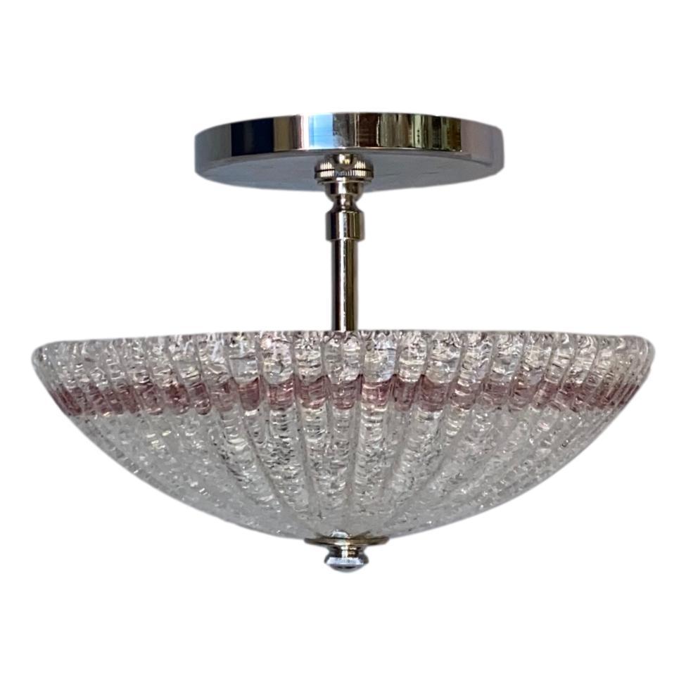 A set of eight circa 1950s Murano clear “ice glass” pendant/semi-flush light fixture with an amethyst-colored detail near the rim, nickel-plated hardware and two interior lights. Sold individually.

Measurements:
Drop 9
