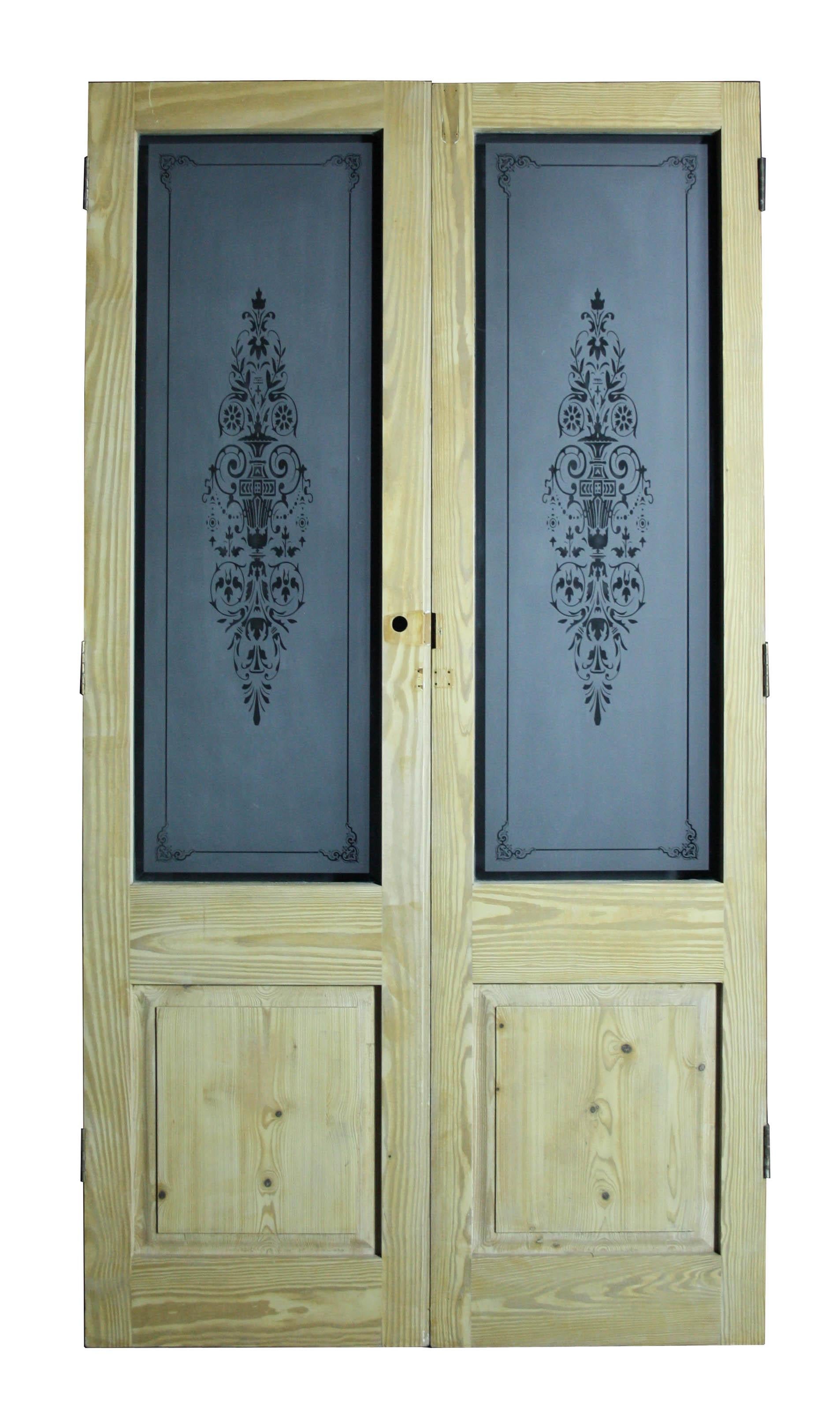 A set of reclaimed exterior or interior doors, fitted with etched glass.