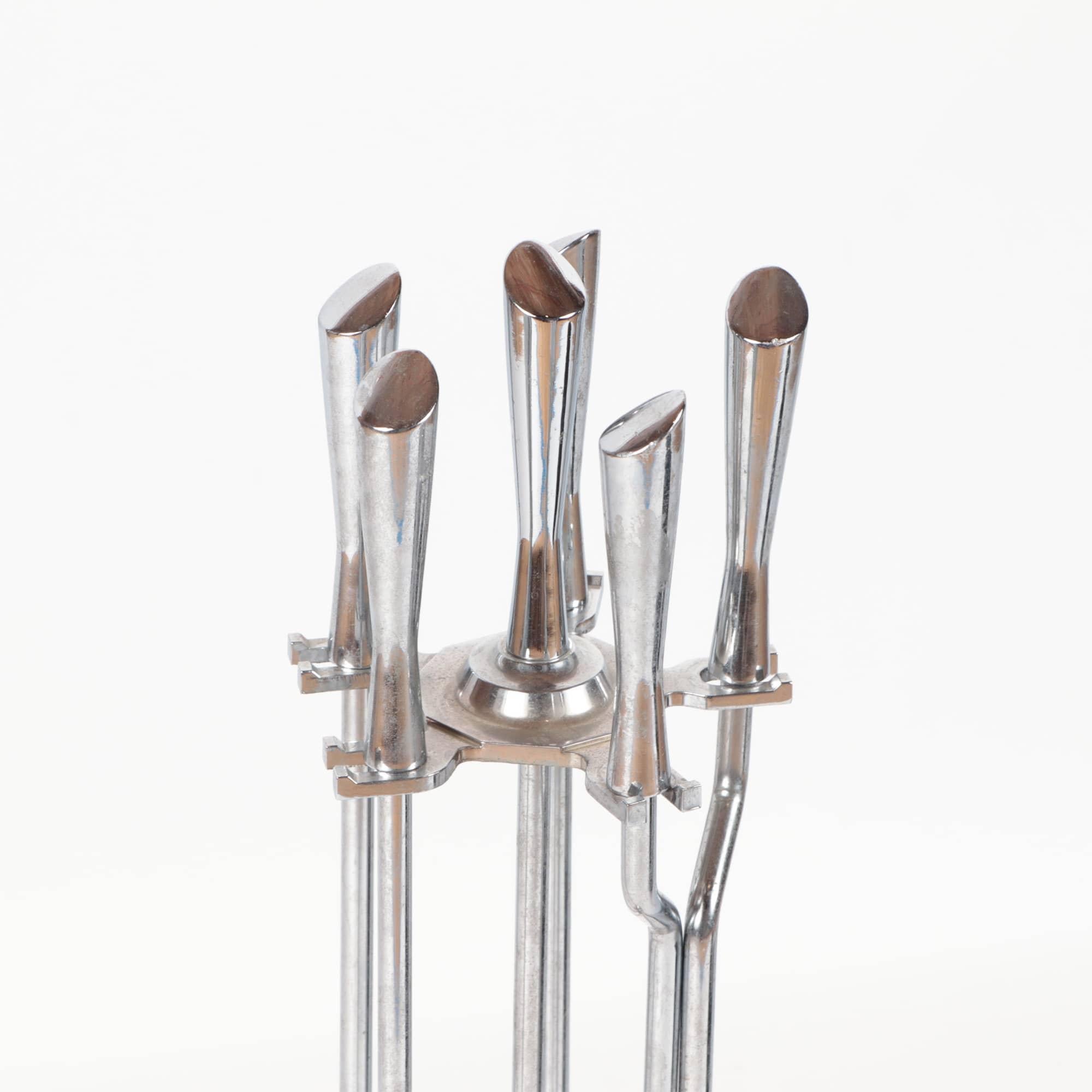 A set of polished chrome fireplace tools in the Modernist taste circa 1960.