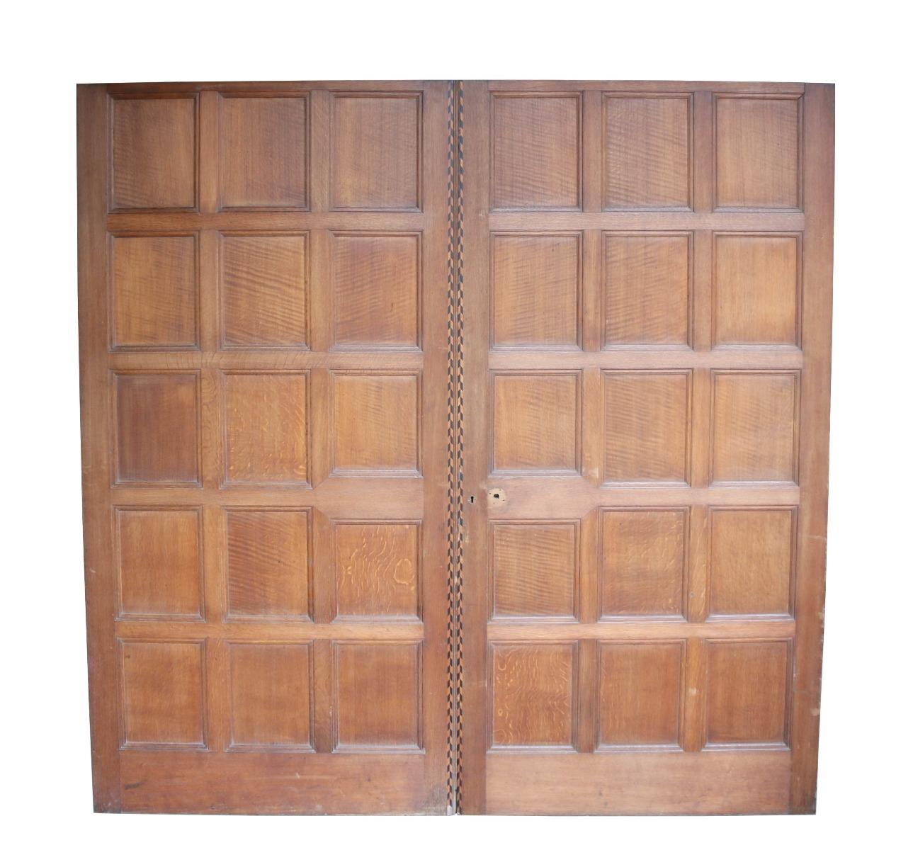 A set of reclaimed sliding or pocket doors, with part of the original mechanism still attached. These doors could be adapted for use with traditional butt hinges if required.