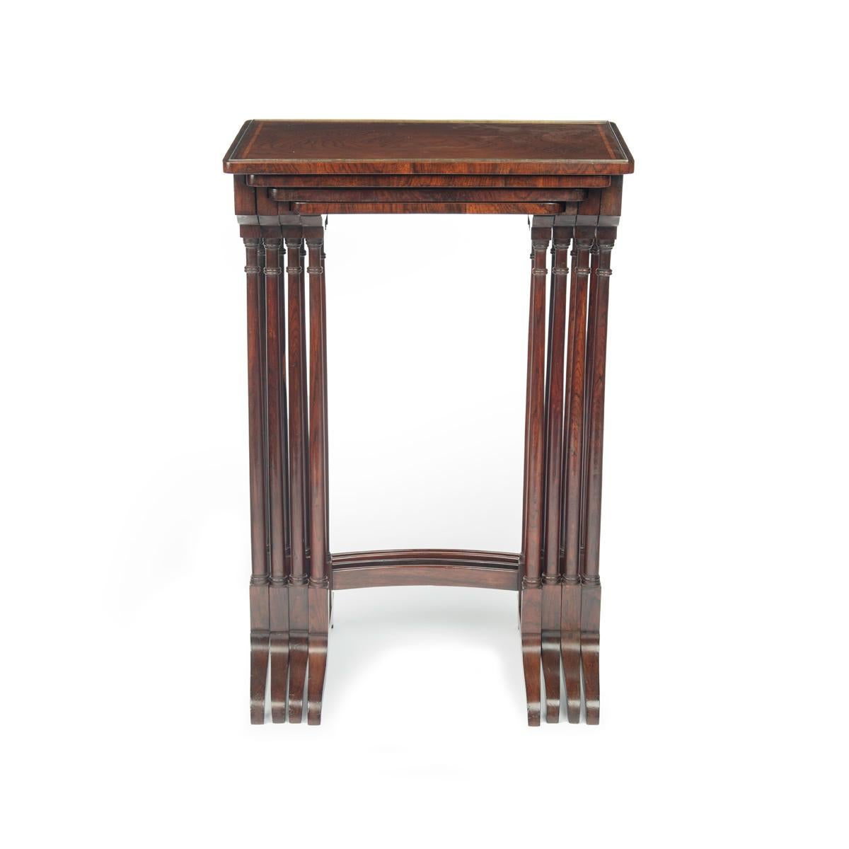 A set of Regency rosewood Quartetto tables, attributed to Gillows, each of rectangular form with well figured veneers, brass cock-beading and satinwood stringing, the solid rosewood end supports comprising paired columns.  English, circa