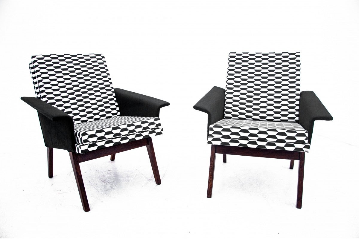 A pair of black and white retro armchairs. Made in Czechoslovakia in the 1960s.

Armchairs with an unusual form of armrests, which are entirely upholstered in fabric. They will work great in modern interiors.

Armchairs after a comprehensive
