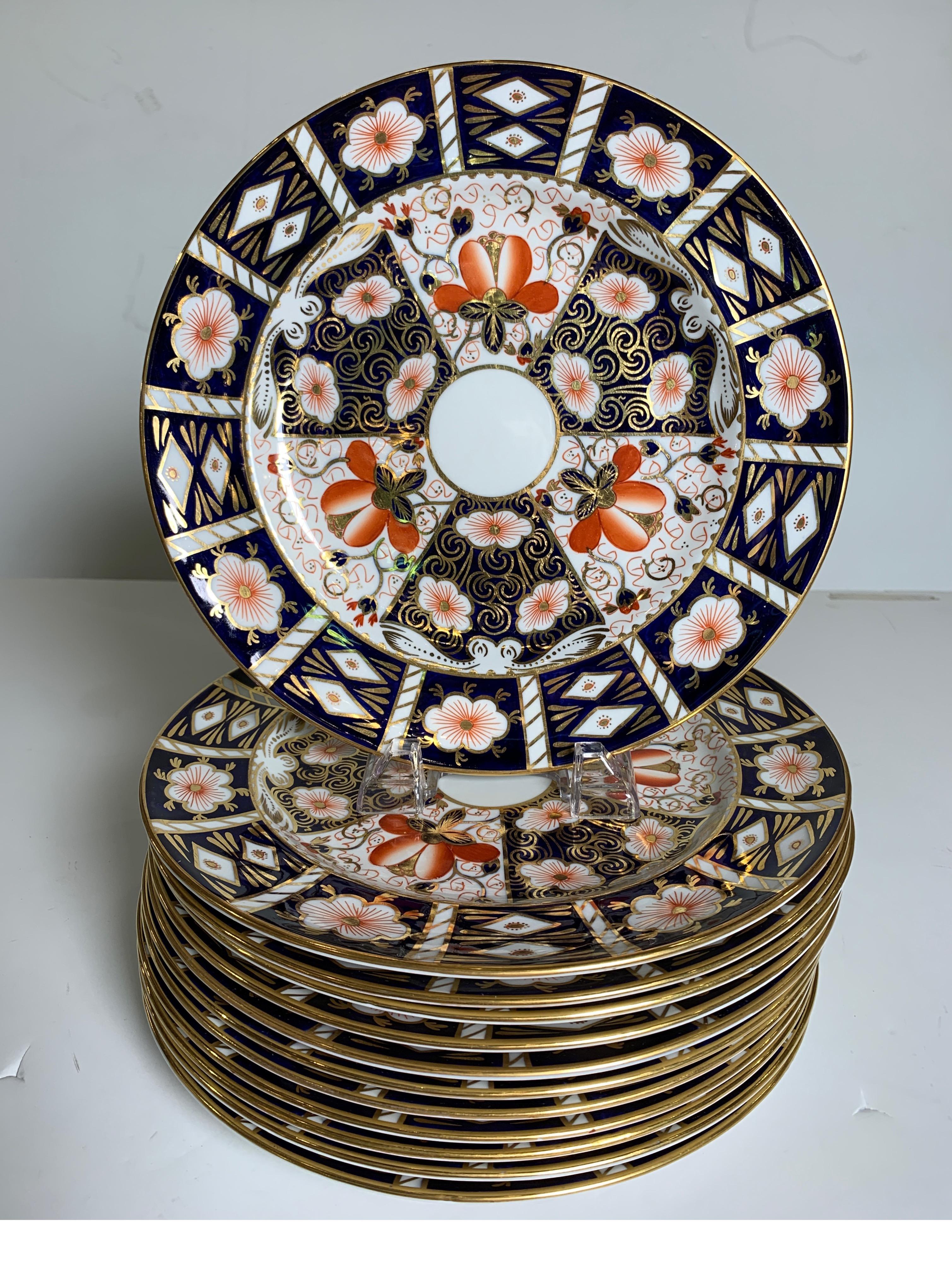 A set of 12 highly sought after Old Imari plates. The detailed Imari pattern with cobalt blue and iron red outlined in hand gilt decoration. These were also retailed from Tiffany in NYC with a year mark of 1940. This pattern by Royal Crown Derby is