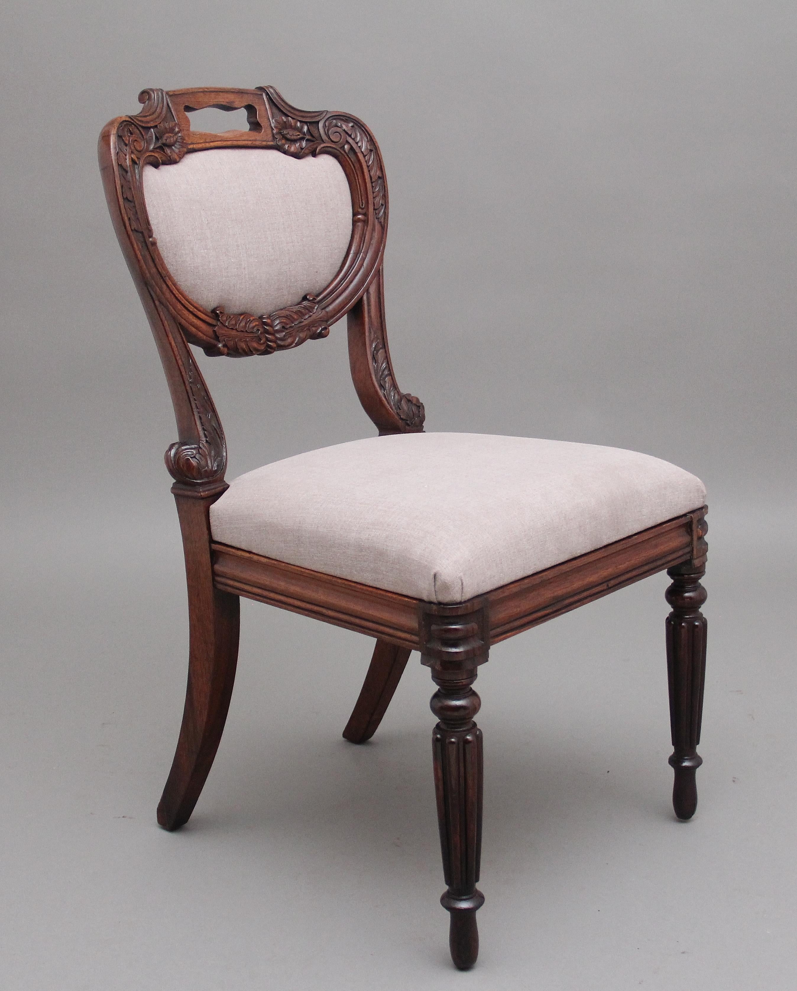 A set of six Anglo Indian rosewood dining chairs, having a highly decorative carved and shaped back incorporating an upholstered padded insert, drop in upholstered seat on shaped rails, supported on rear out swept legs and turned and fluted front