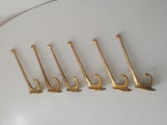 A Set of Six Art Nouveau Brass Coat Hooks