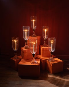 Pair of brass and hurricane glass lamps