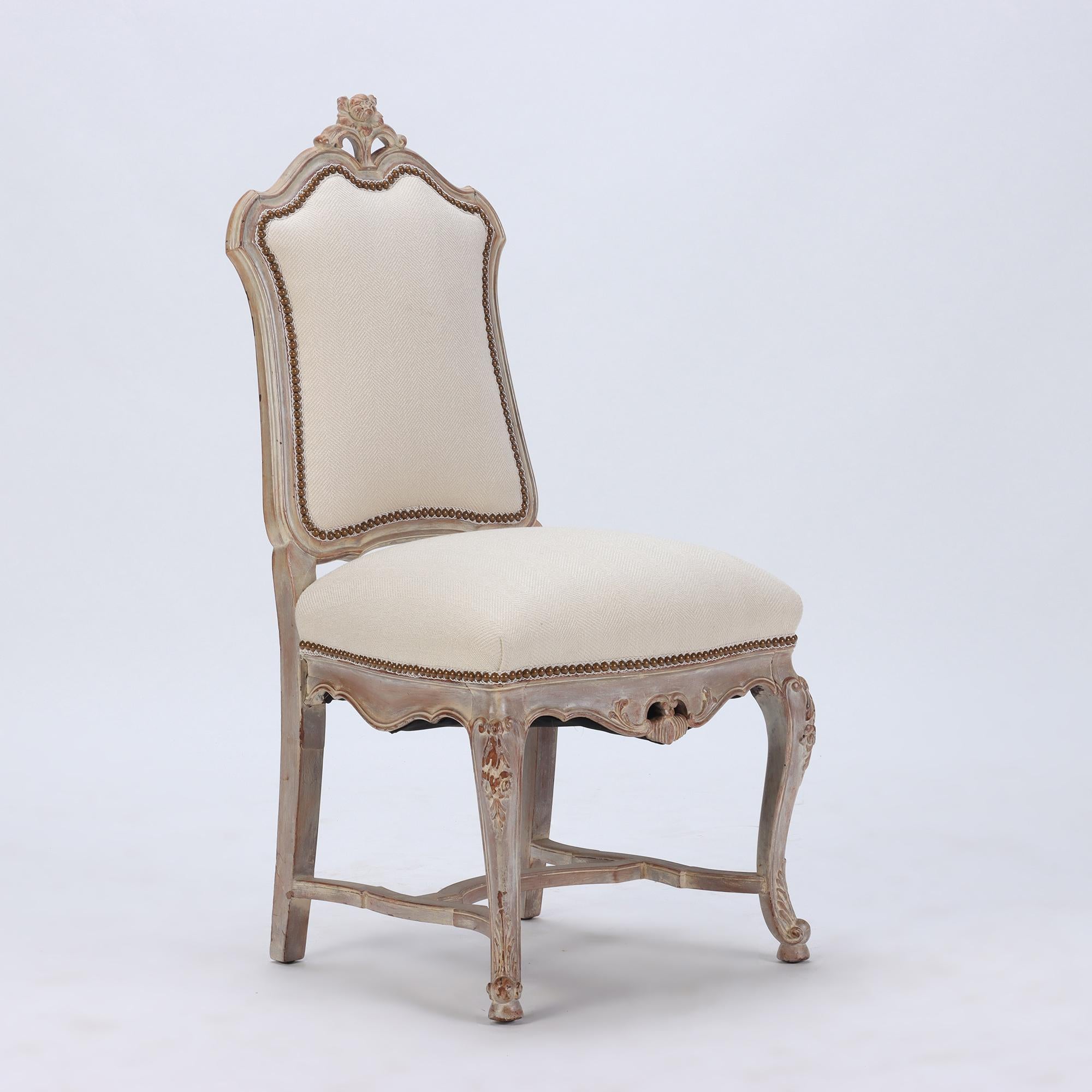 A set of six carved and painted Regency style upholstered dining chairs. Pickled walnut. C 1920.