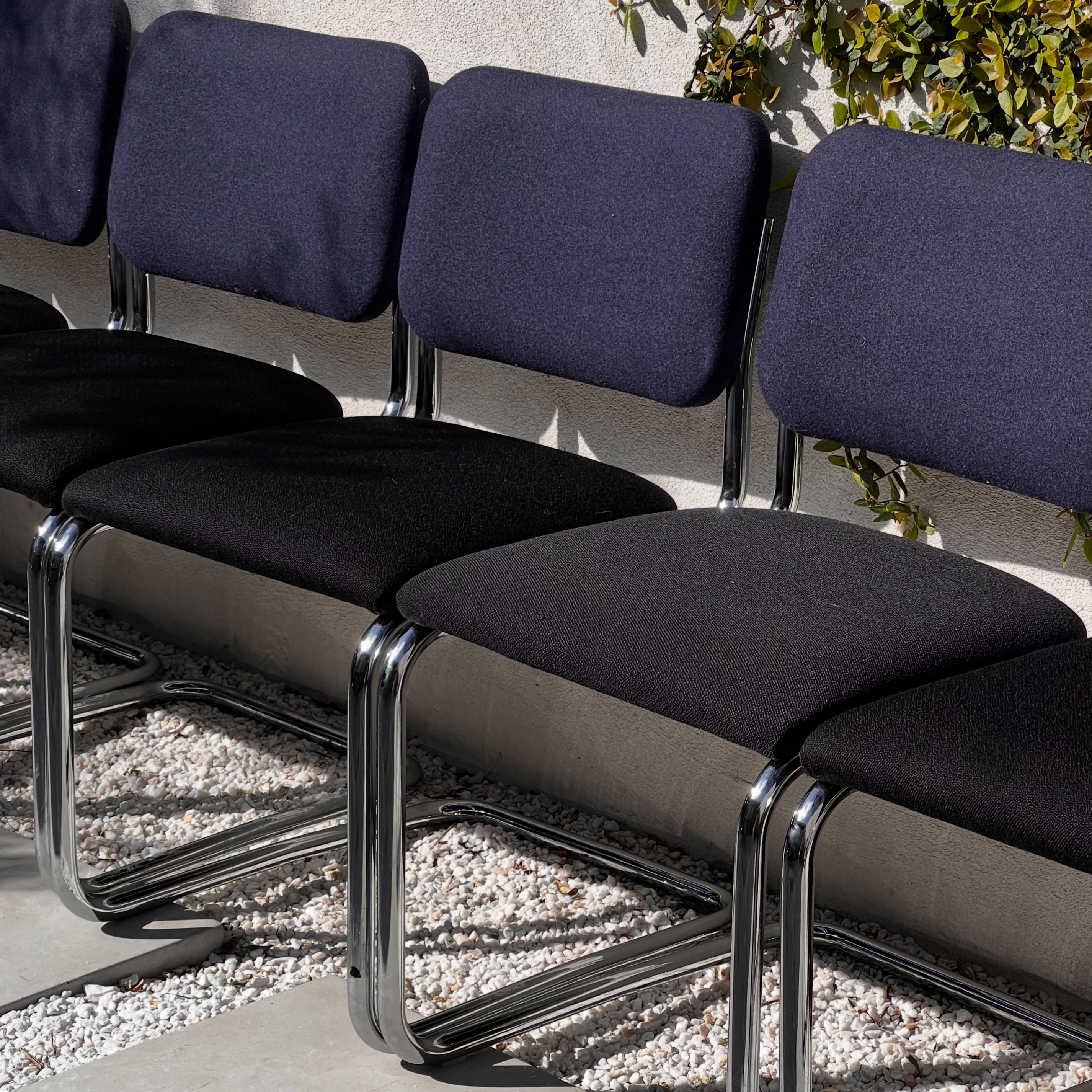A set of six Cesca 51C dining chairs by Marcel Bruer for Knoll, 20th century. These chairs feature a cantilever chrome frame and a two-tone fabric motif with black seat and midnight blue back. Designed in 1929 by Marcel Breuer, these iterations are