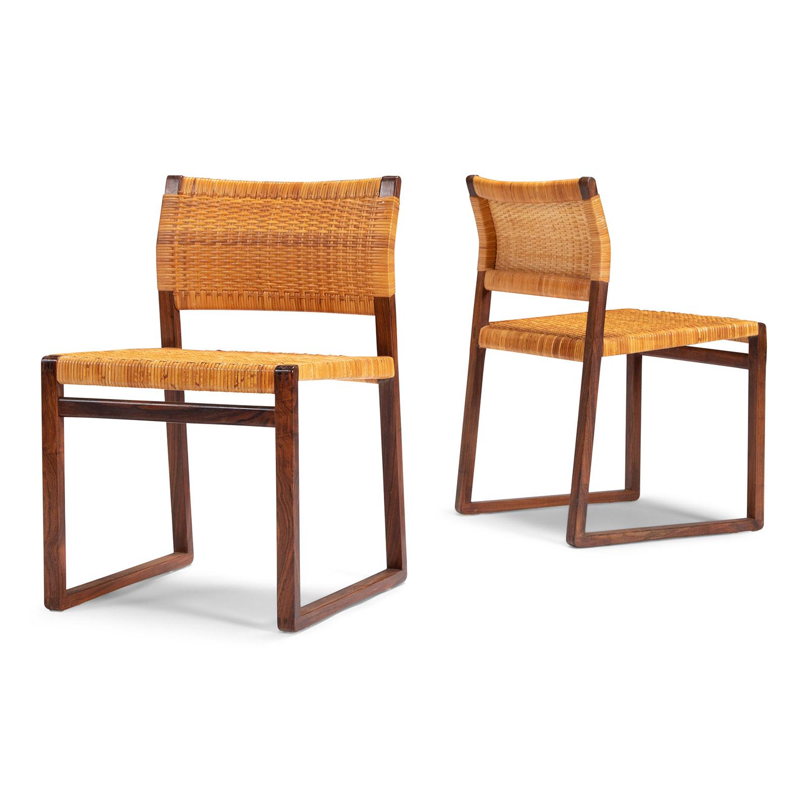 A set of elegant dining chairs with frames of solid rosewood and original cane seat and back. Designed by Børge Mogensen in 1957, made by P. Lauritzen, Denmark.