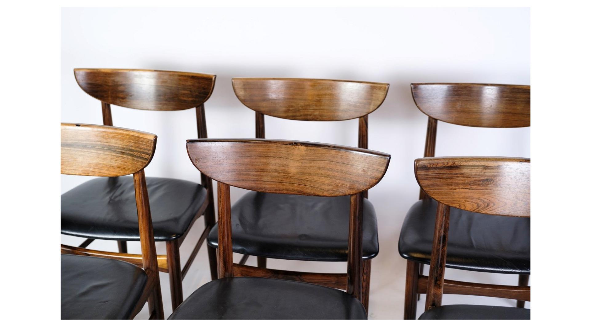Danish design from the 1960s, this set of six dining table chairs combines the rich allure of rosewood with the timeless sophistication of black leather upholstery.

Crafted with meticulous attention to detail, these chairs exude a sense of