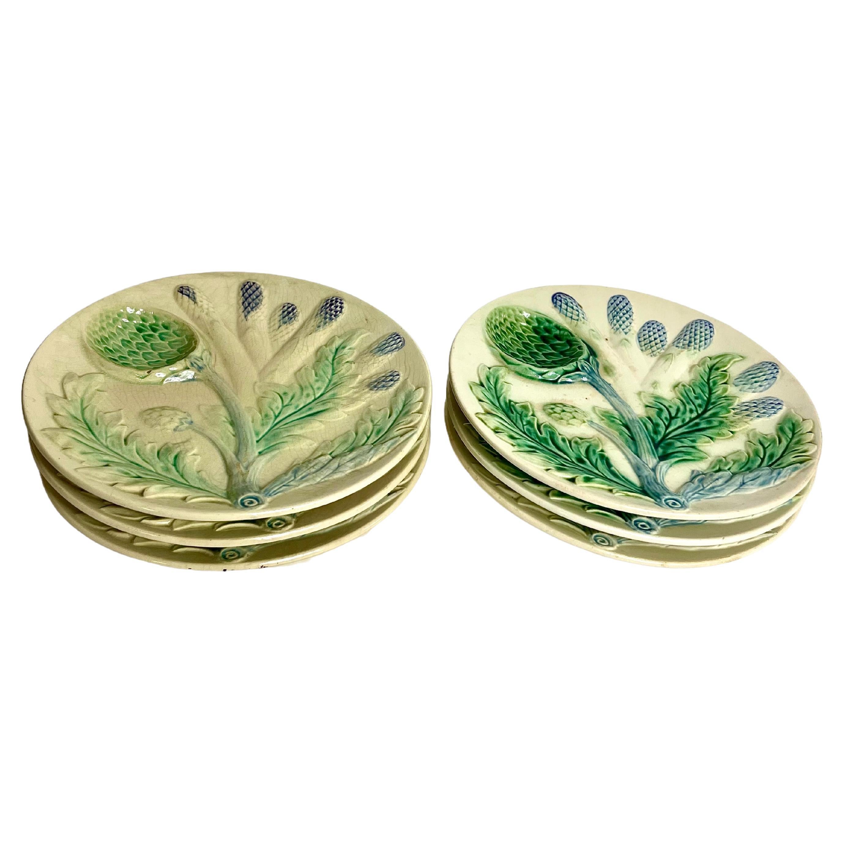 A set of six eye-catching Majolica porcelain asparagus or artichoke serving plates, featuring a beautifully detailed design of asparagus and artichokes in relief, with subtle colour gradation in tones of green and blue. Thought to be originate from