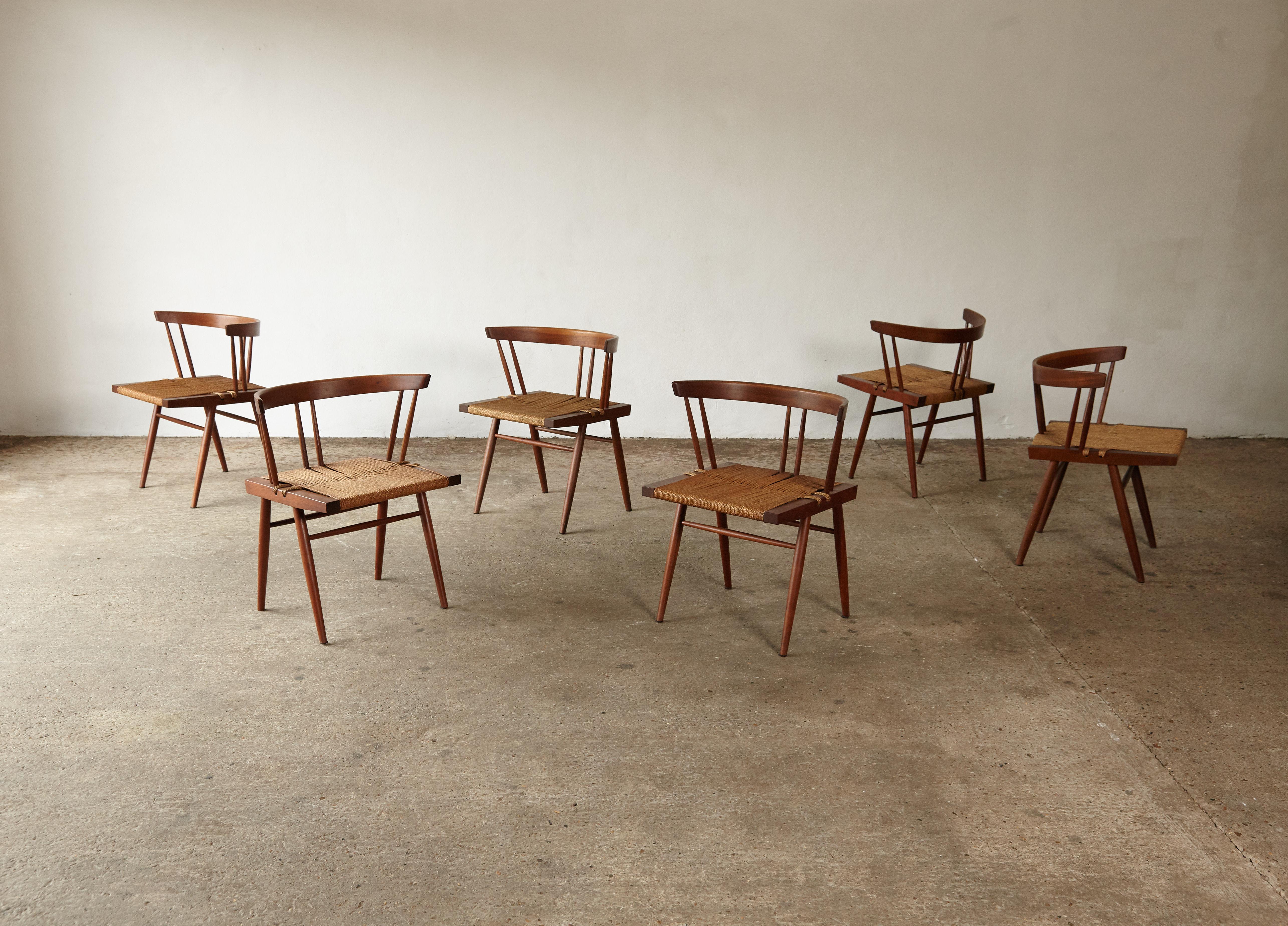 A stunning set of six George Nakashima grass seat chairs, made by Nakashima Studio, New Hope Pennsylvania, USA, 1950s-1960s. Walnut and grass cord. In original condition with a wonderful warm patina. A single owner set with provenance and copies of