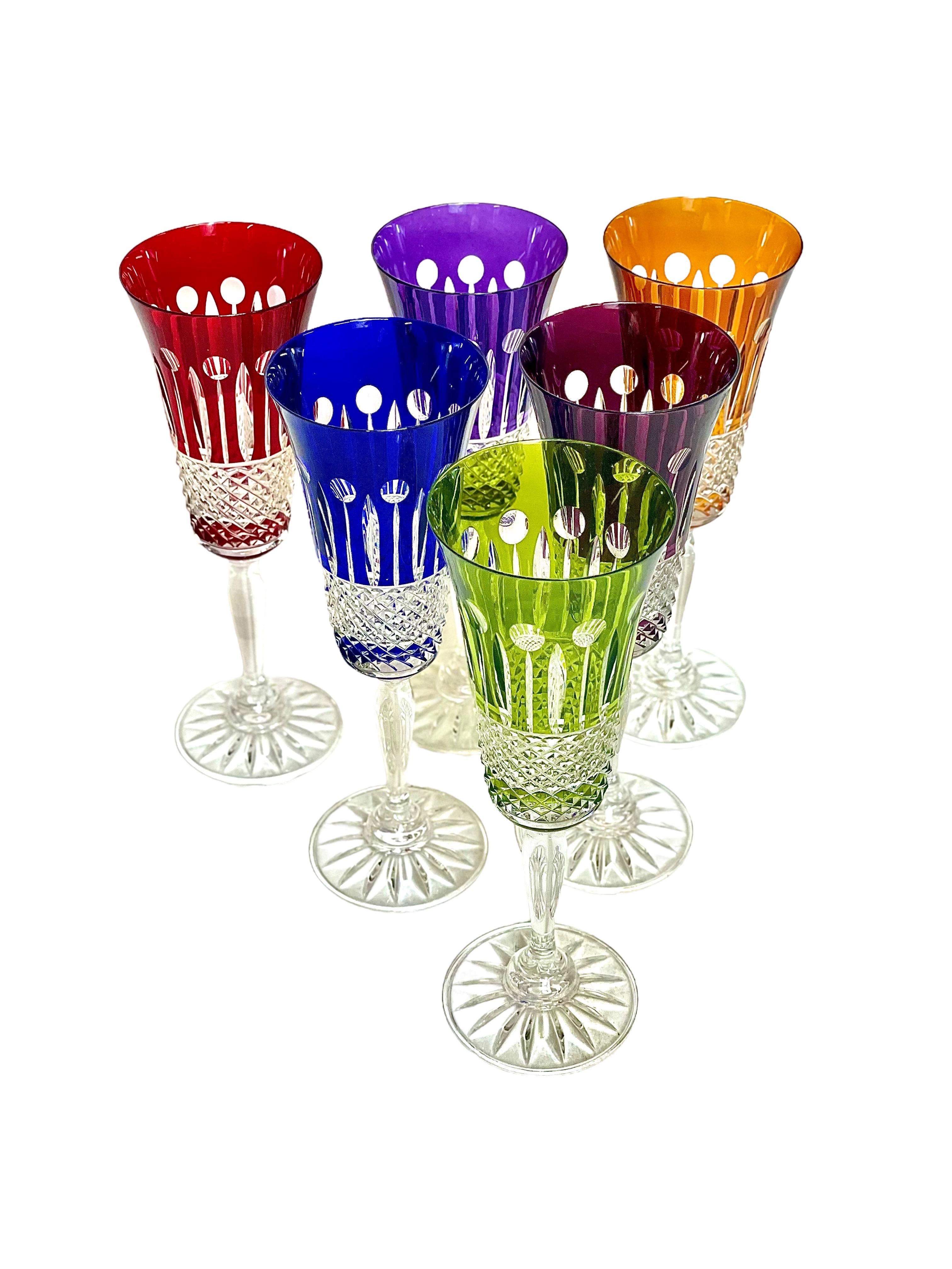 A vibrant set of six Champagne flutes made by the celebrated Compagnie des Cristalleries de Saint Louis in Lorraine, the oldest glass manufacturer in France, dating back to 1586. Mouth-blown and hand-cut, this set is part of the famous 'Tommy'