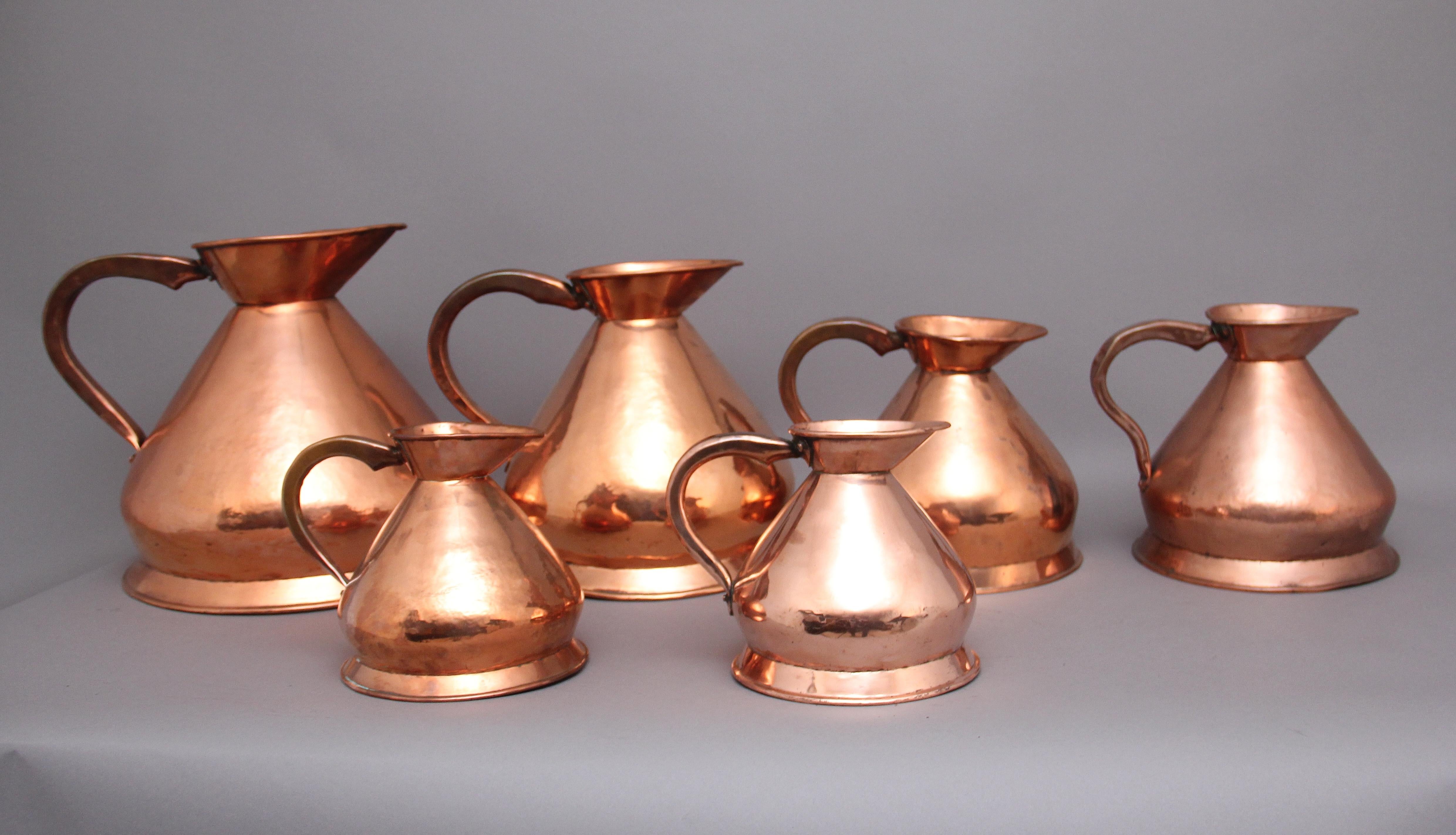 British A set of six highly decorative 19th Century copper measuring jugs For Sale
