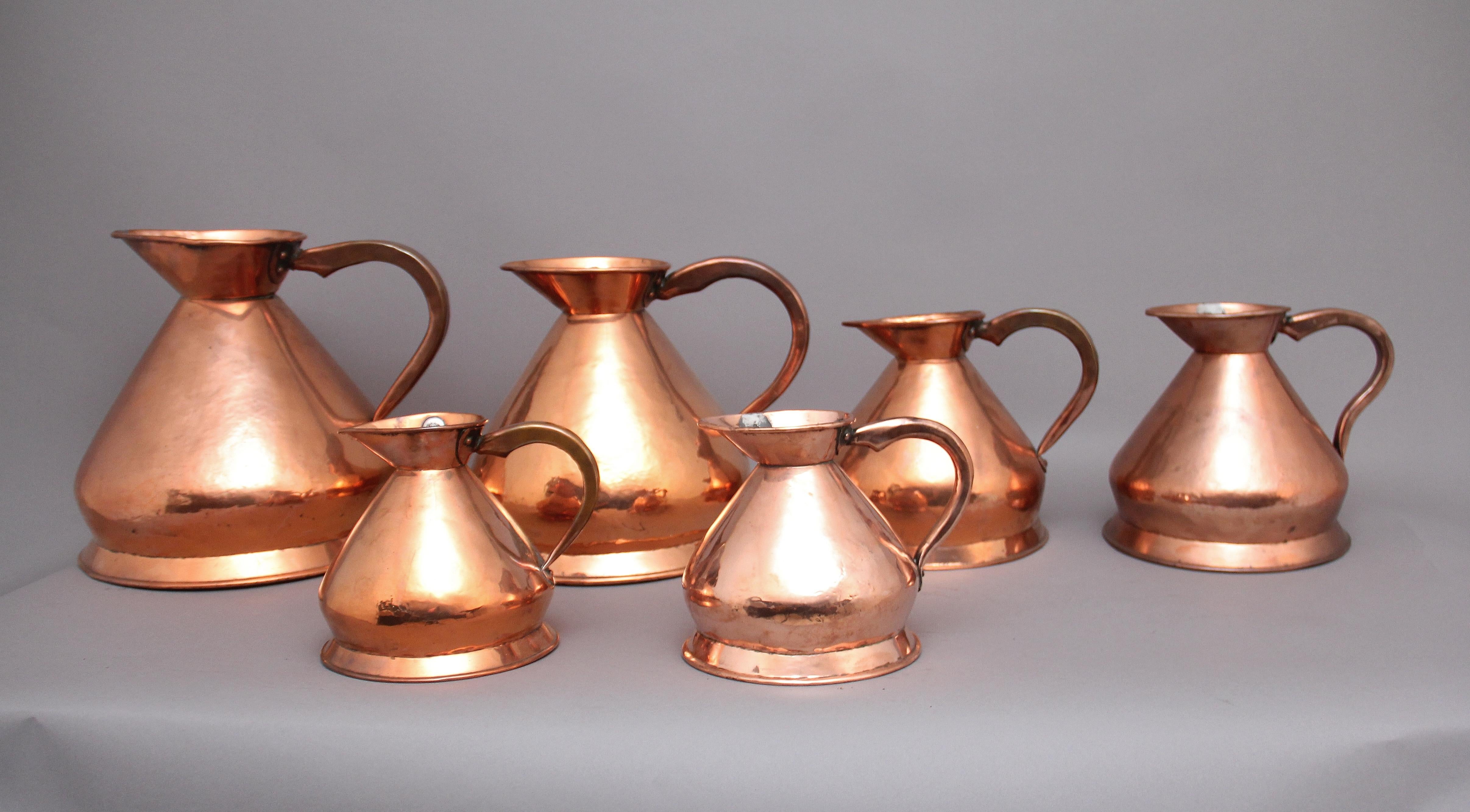 Late 19th Century A set of six highly decorative 19th Century copper measuring jugs For Sale