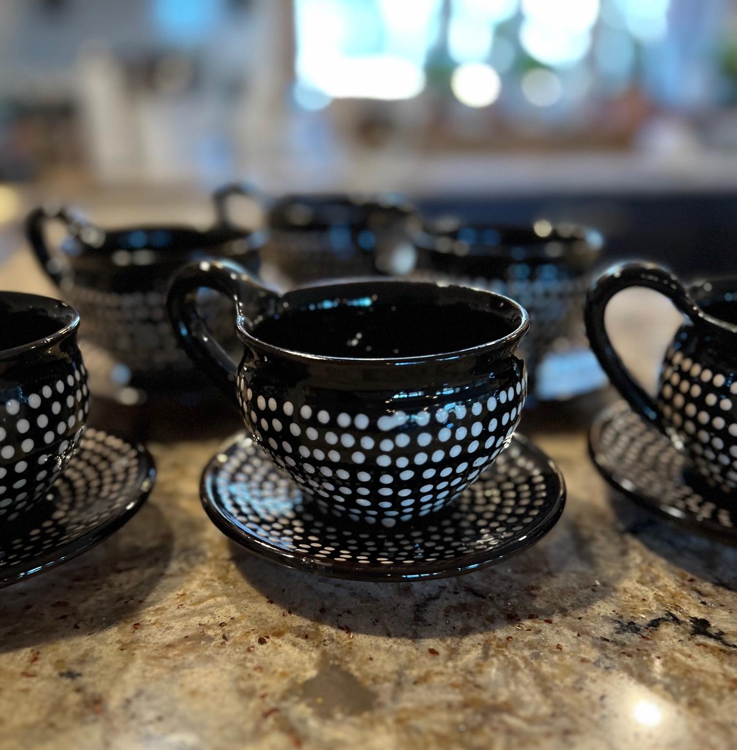 A set of 6 Hungarian Folk Art Red Ware tea cups and saucers by Imre Szűcs. A black/brown based glaze decorated with white dots. The undersides are signed by Imre Albert Szucs and marked Hungary. 

Dimensions:
Cup:
4.75
