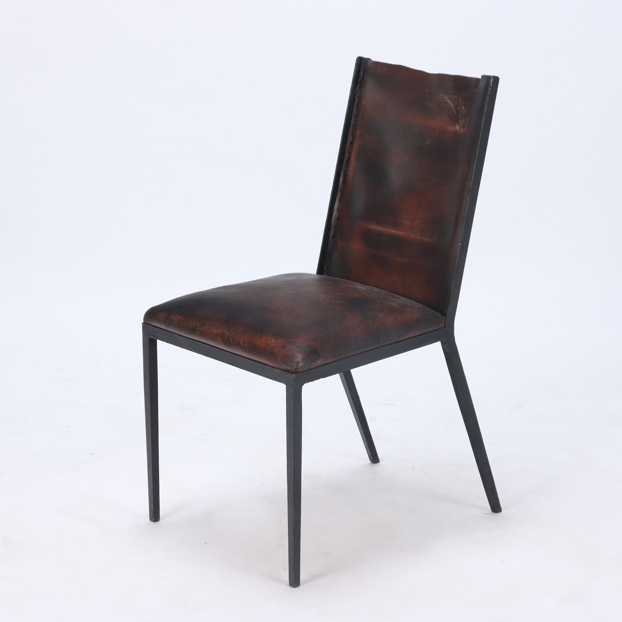 A set of six iron and leather chairs. Contemporary. After Jean-Michel Frank.